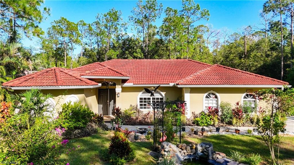 PRIVATE ACREAGE LIVING IN GOLDEN GATE ESTATES! Discover the freedom and privacy of this exceptional 3-bedroom, 2-bath Naples property situated on 2.34 ACRES! Enjoy your own outdoor oasis featuring a screened-in pool and spa, perfect for relaxing and entertaining. Inside, distinctive architectural details add character, including a beautiful wood ceiling in the primary bathroom and decorative accented ceilings in the bedrooms. A keypad-controlled gated entry provides added privacy, while the durable tile roof and remote-access 2-car garage offer convenience. RV enthusiasts will appreciate the dedicated RV pad with hookups, adding flexibility for travel and recreation. With generous acreage, unique interior details, and inviting outdoor living, this property offers a special opportunity to enjoy space, privacy, and the Southwest Florida lifestyle—all within reach of Naples shopping, dining, and recreation. Experience the possibilities of acreage living!