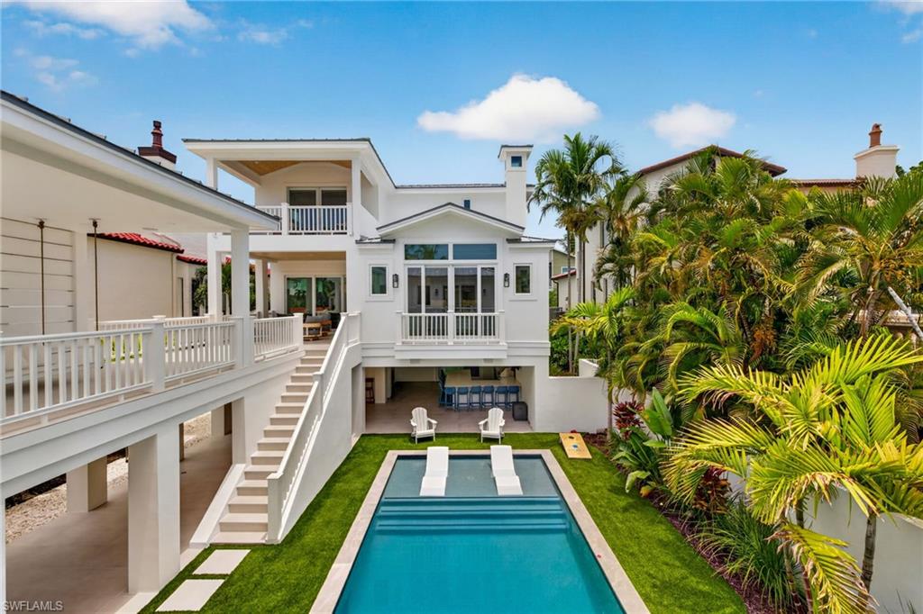 Xanadu is a rare expression of contemporary coastal architecture in the heart of Captiva's historic Village. Completely reimagined and rebuilt from the concrete structure up following its 2024 acquisition, every element is new, from the impact windows, Hardie siding and stucco exterior to every interior finish, mechanical system and luxury amenity. On iconic Andy Rosse Lane, Captiva's most celebrated address, the home places you just moments from nightly sunset celebrations, waterfront dining and the unmistakable soundtrack of island musicians carried on the Gulf breezes. Inside, the interiors embrace the principles of quiet luxury, where thoughtful restraint replaces excess. Exposed scissor trusses with concealed lighting, a modern recessed coffered dining ceiling, flush inset solid wood cabinetry, contemporary three-panel shaker doors, square-edge casing and refined craftsman-inspired trim create an architectural language defined by crisp lines and impeccable proportions. A palette of warm whites, soft taupe's, greige, sand, natural wood and coastal blues complements meticulous drywall detailing and clean trim reveals throughout. The kitchen is sculptural and functional, anchored by a dramatic Brizo bridge faucet and equipped with a full suite of Thermador appliances including an induction range, side-by-side refrigerator with four freezer drawers, drawer microwave and refrigeration drawers serving the adjoining wet bar with hammered sink. Lutron automated shades, whole-home Sonos audio and enterprise-grade Wi-Fi deliver effortless comfort and technology. Designed for entertaining as much as everyday living, a dramatic open-air gallery stretches the length of the residence, framed by crisp columns, a warm tongue-and-groove ceiling and expansive views of the courtyard and pool. Outdoors, a resort-inspired setting unfolds with a newly reconstructed linear pool and spa, sun cabana with suspended daybed swing, outdoor shower and a fully equipped outdoor kitchen featuring grill, ice maker, beverage cooler, sink, television and bar seating for 12. The custom bunk room maximizes sleeping accommodations without compromising design, while a thoughtfully conceived carriage house offers exceptional flexibility. Two private guest suites may function together with a shared morning kitchen or independently, each with its exterior entrance overlooking the central courtyard promenade. Built with solid concrete construction through the first level, a Navien tankless water heater and every modern system expected of luxury new construction, Xanadu is an exceptional legacy property that seamlessly blends timeless island living with sophisticated contemporary design on Captiva's most desired street.