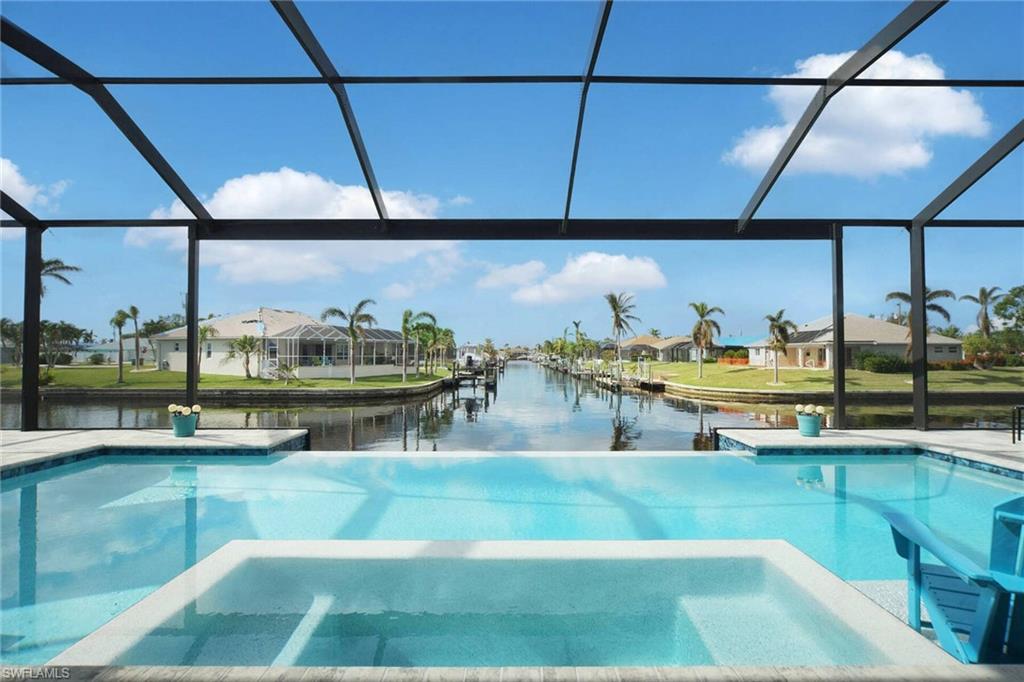 *** Modern Luxury Custom Home with Breathtaking Waterfront Views & Fully Turnkey! *** Welcome to a custom-designed modern retreat crafted for seamless indoor-outdoor living and panoramic views. This magnificent home features a master suite, a junior suite, an ensuite guest bedroom, and a versatile den complete with a sleeper sofa. At the heart of the home is a stylish gourmet kitchen equipped with upgraded black stainless steel appliances, a massive center island, rich granite countertops, and solid white wood cabinetry. The open-concept floor plan is highlighted by soaring tray ceilings, elegant large-format tile flooring throughout, and hurricane-impact windows and doors for complete peace of mind. Designed around an exceptional outdoor lifestyle, the home opens to an expansive 60' x 23' brick-paver pool deck and a 51' x 12' covered lanai with ample space for dining and lounging. The crown jewel is the oversized, fully automated saltwater pool featuring a 20-foot wide infinity edge, dual electric and solar heating, a sun shelf, and a 6-person, 270-degree spillover spa adorned with sparkling glass tile. Key Upgrades & Features are : ?Turnkey Living: Offered fully furnished, including all decor and accessories—just bring your toothbrush, ?Garage & Storage: 3-car garage with durable epoxy flooring. Energy Efficiency & Safety: Spray-foam roof insulation and storm-impact protection windows and doors. Utilities & Elevation: High ground elevation with zero history of flooding; all city utilities are fully paid. Don't wait and join the Florida Lifestyle!