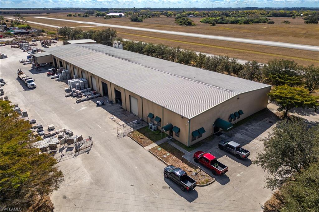 Located in the path of progress, offers exceptional access and infrastructure on 4.44± acres. The property features a 30,000± square-foot main warehouse/manufacturing facility with office and showroom, equipped with 20 roll-up bay doors, 800-amp 3-phase power, and fenced, lighted outdoor storage. The property is ready for immediate occupancy. 

Strategically positioned with easy four-lane highway access to US Hwy 27, Hwy 80, and I-75, the site is centrally located within approximately 30 minutes of Fort Myers and Cape Coral, 2.5 hours to Orlando or Tampa, and 2 hours to Miami/Fort Lauderdale.

Location Details: Situated adjacent to the LaBelle Municipal Airport, the property is zoned Heavy Industrial (I-2). In addition to the main facility.

Property Highlights:
• 6 offices, showroom, and conference room
• 20 bay doors (10 west side / 10 east side)
• 800-amp 3-phase electric service
• 4 restrooms plus kitchen and breakroom
• Entire 4.44± acres fully fenced with 8-foot security fencing (excluding parking area)
• Extensive outdoor storage capacity