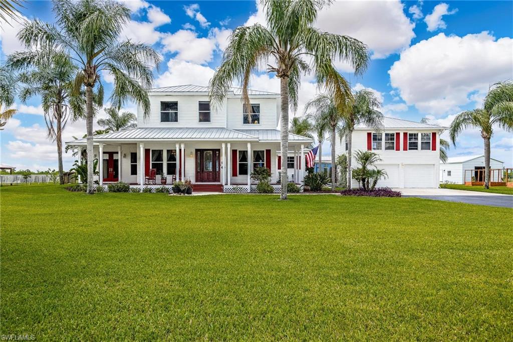 Welcome to this charming and inviting Mini-Ranch located in the Port LaBelle Ranchettes Development at 1323 Frontier Circle in the beautiful town of LaBelle, Florida. Nestled in a tranquil neighborhood, this property offers a perfect blend of comfort, style, and convenience. With its spacious interior, attractive features, and prime location, this home is an exceptional opportunity for prospective buyers.   This home spans approximately 3,456 square feet and sits on a generous 2.53 acre riverfront access lot, providing ample space for all your needs.   The thoughtful layout encompasses 3 bedrooms and 3 1/2 bathrooms, offering comfortable living spaces for the whole family.  The home is two story  and recently completely updated master bath.  The kitchen has been recently updated also with new quartz counters and appliances.  Outdoor screen gazebo over looks the pool and spa;  Whole house generator with (2) 250 gallon inground propane tanks, central vacum system, hardwood floor, fireplace, fenced property fully irrigated and gated entrance with call box and programmable codes. outdoor landscape lighting and an office/rec room or future apartment over the 2 car garage.