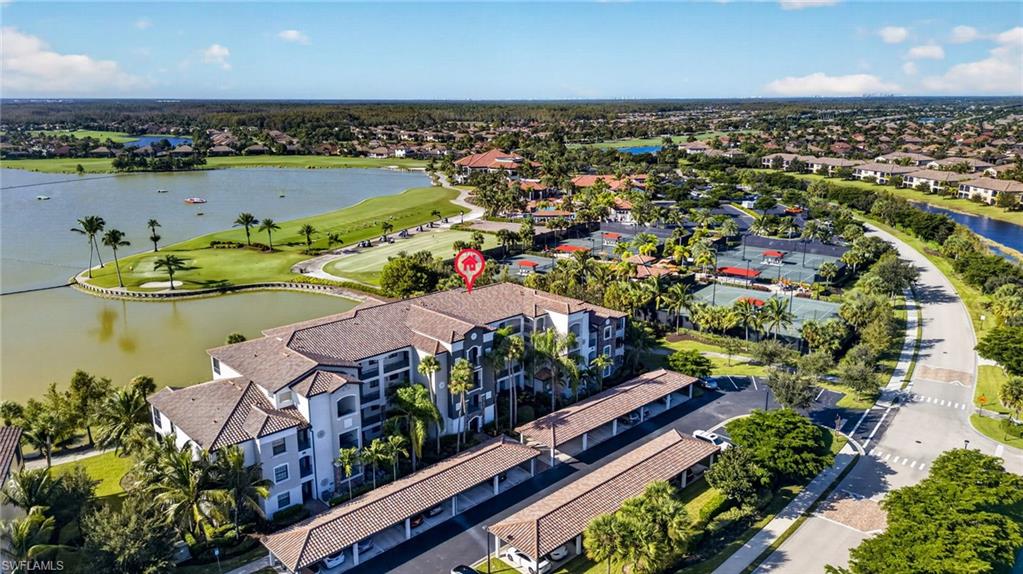 Welcome to your new condo in Bonita National! Pulling into your covered carport space, your private exterior storage unit is just steps down the walkway—giving you a dedicated, secure spot for tennis rackets, bikes, and beach gear before you reach your front door.  Walking up to this fully furnished, ground-floor Antonia floor plan, you enjoy single-level ease with zero stairs or elevator waits. The front entry opens to an inviting hallway with high ceilings, tile flooring, and crown molding that leads you into the main living and dining spaces. At the center of the home is a stunning, top-to-bottom remodeled kitchen featuring bright white cabinetry with black hardware, a new sink, quartz countertops, a subway tile backsplash, stainless steel GE appliances, a cozy eating nook, and a breakfast bar styled with custom vertical slat accent panelling underneath. Passing the kitchen, you enter a formal dining area centered beneath a stylish upgraded ceiling light fixture, which flows seamlessly into the bright Great Room. Wide sliding glass doors lead out to a private screened lanai with southern exposure, bringing in all-day natural sunlight over the beautiful lake and golf course. Back inside and tucked off the main area, the primary suite has cozy carpet, a walk-in closet, an en-suite bath featuring a dual-sink granite vanity and tiled shower, and a large window highlighting those same serene water views. Back toward the entry, the guest wing offers complete privacy with a spacious second bedroom located right across from a dedicated full bath complete with a convenient bi-fold laundry closet. Offered with a Social Membership, you enjoy full access to the community lifestyle without annual golf dues—while still having the flexibility to play the championship course as a guest of a member or off-season at the prevailing guest rate! Best of all, this condo is ideally situated directly adjacent to Bonita National's world-class amenities—putting the course, driving range, tennis and pickleball courts, resort-style lagoon pool, and clubhouse just a short walk from your front door! Schedule your private tour today to experience this resort-style condo for yourself!