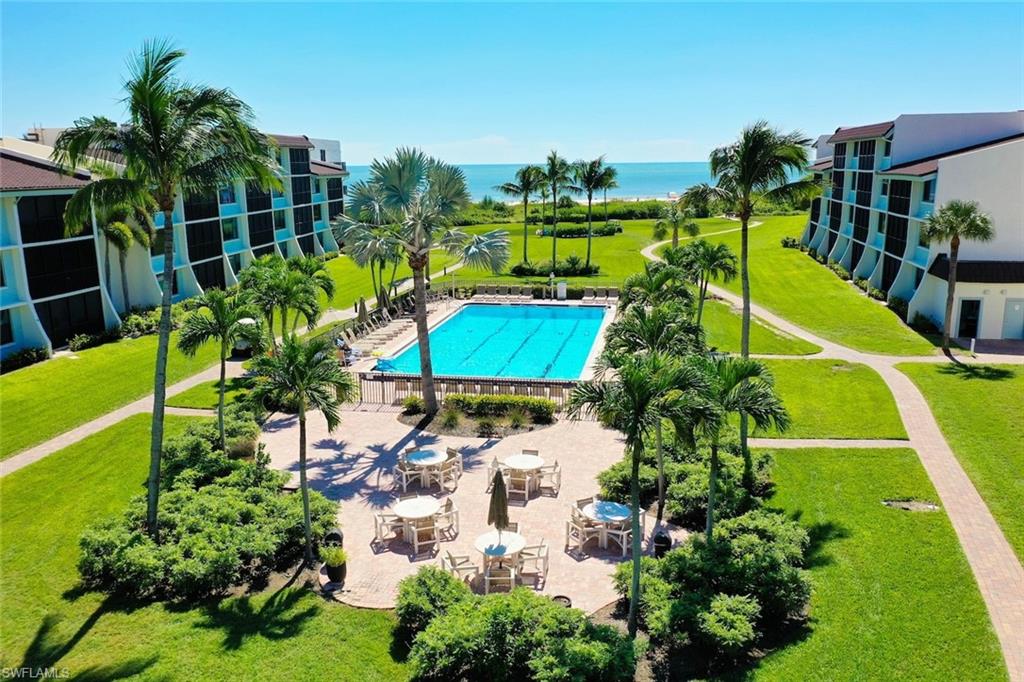 The beach is just steps outside your front door. This turnkey, fully furnished 2-bedroom, 2-bath corner unit is one of the most private spots in Loggerhead Cay, with direct beach access, Sanibel’s bike path at your doorstep, and a rental program already in place. Coastal wood accents give it a bright, classic beach-house feel. The kitchen has quartz countertops, an open plan walk-around island that opens to the living area, and stainless appliances. The screened lanai is a real highlight. It is enclosed with high-end impact glass and retractable sliders, so you can open it to the Gulf breezes or close it up and cool the space. There’s a comfortable sectional dining area with room for everyone, and it works well for morning coffee or sunset dinners. Loggerhead Cay’s grounds include a heated pool, tennis, shuffleboard, and gas grills, all a short walk from one of Sanibel’s beaches. Move-in ready, rental-ready, turn-key and fully furnished.
