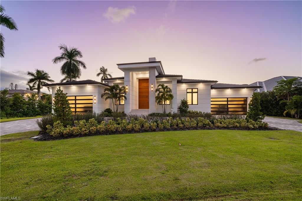 This Italian-inspired modern coastal residence sits on an oversized 0.40-acre lot in the heart of the Moorings community. Set at 12 feet of elevation, the home showcases refined European craftsmanship throughout. Porcelanosa is used for the flooring in all interior living spaces, the wall finishes and showers in every bathroom, and the outdoor kitchen backsplash. All cabinetry, including the kitchen and custom closet systems, was designed, built, and imported from Italy by Copatlife. The minimalist interior has no baseboards, crown molding, door frames, or traditional door hardware. Interior doors are Italian-made pivot doors by Ghizzi & Benatti, set flush into the walls with integrated hand-slot pulls, while the entry makes a statement with a show-stopping Andersen pivot door.
The kitchen features Gaggenau appliances, including an integrated refrigerator and freezer, two full ovens plus a steam oven, and dual dishwashers, along with onyx countertops and a flush cooktop with a built-in pop-up downdraft ventilation system.
Additional features include a full Lutron lighting system, a Pentair whole-home water filtration system, a 1,000-gallon propane tank, Andersen LiftSlide glass doors, and Andersen impact windows. Expansive indoor-outdoor living is complete with a custom pool, spa, sunken fire-pit, outdoor kitchen, and electric screens and shutters.  This property is eligible for the private Moorings Beach Park.