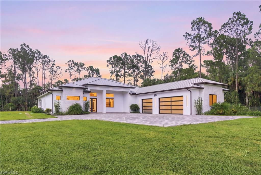 Brand-new 2026 construction on 2.81 fully fenced, 100% upland acres with no HOA. This 5-bedroom, 3.5-bath home offers 3,256 square feet, a 3-car garage, a metal roof, and impact windows and doors. Outside you'll find an outdoor kitchen, mature fruit trees, and room for a pool.

Picture your mornings on the covered lanai, coffee in hand, looking out over land that is all yours. Every acre is usable, with open lawn around the home and a wooded buffer at the back for privacy.

Inside, wood-slat tray ceilings and large-format porcelain tile set the tone. The great room is anchored by a media wall and electric fireplace. The kitchen is made for gathering, with custom cabinetry, a waterfall island that seats five, stainless appliances, and a walk-in pantry with a beverage cooler.

The split floor plan gives the primary suite its own wing, with two custom walk-in closets and a spa bath featuring a freestanding jetted tub and two glass showers. Four more bedrooms give everyone room to spread out, and one works just as well as a home office or guest room.

Built with concrete block and finished with care, the home also includes a whole-house reverse osmosis system, two A/C units, and a garage with epoxy floors.

This corner lot sits right off Golden Gate Blvd, with an easy drive to shopping, dining, healthcare, and I-75. Schedule your private showing today.