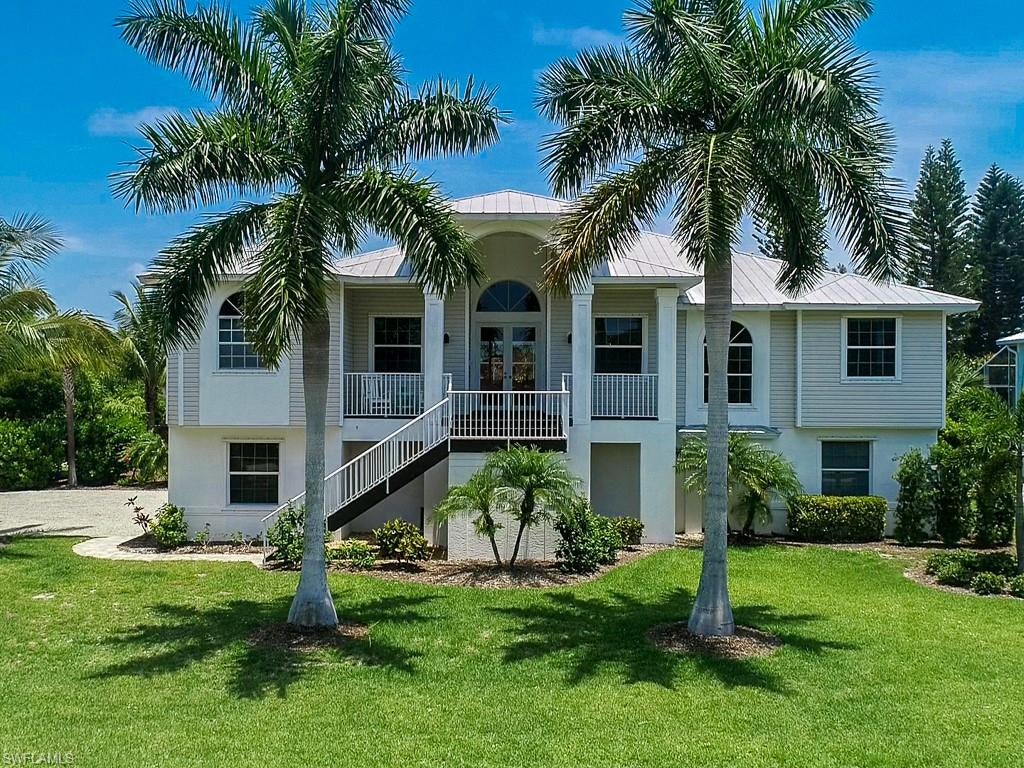 You can have it all!  Close to the beautiful West Gulf Drive beaches this impeccable home features 3 bedroom 2.5 bath split floor plan and is completely updated and ready to move in.  Beautifully appointed chef’s kitchen with granite counters, stainless steel appliances, high-end cabinetry and tile-work.  Custom bar area with built-in wine and beverage cooler.  High ceilings and wood floors accent the light and bright open concept with sliders leading out to an expansive porch overlooking the screened pool and hot tub.  The perfect place to relax and enjoy an al fresco meal.  Large master suite with dual vanities, soaking tub, separate shower and his and hers walk-in closets.  Bonus room perfect for a home office or a cozy TV room.  Three car garage and ample storage add to the long list of amenities.  This is an exceptional home situated on a spacious lushly vegetated lot close to the deeded beach and all that Sanibel Island has to offer.  Don’t miss your chance to own a piece of paradise!