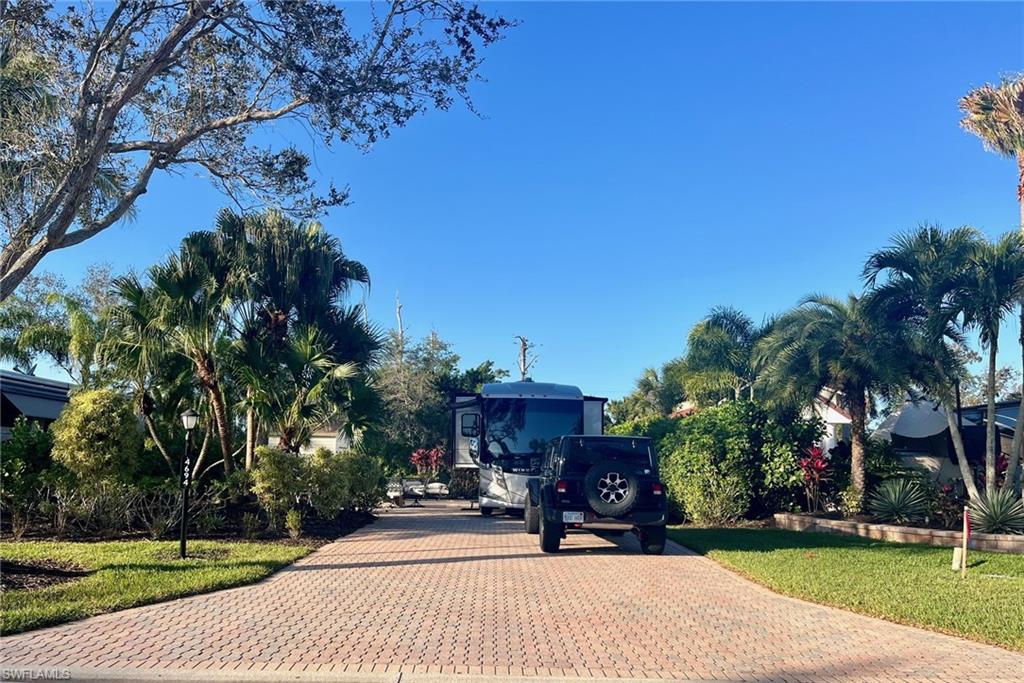 Price Reduction!  This is an off-lake site located in Pelican Lake Motorcoach Resort in Naples, FL. This attractively priced property offers a chance to own a site featuring a paver pad surrounded with tasteful tropical landscaping. The 10x10 coach house is complete, and a new marine-style pedestal was installed in the fall of 2023.