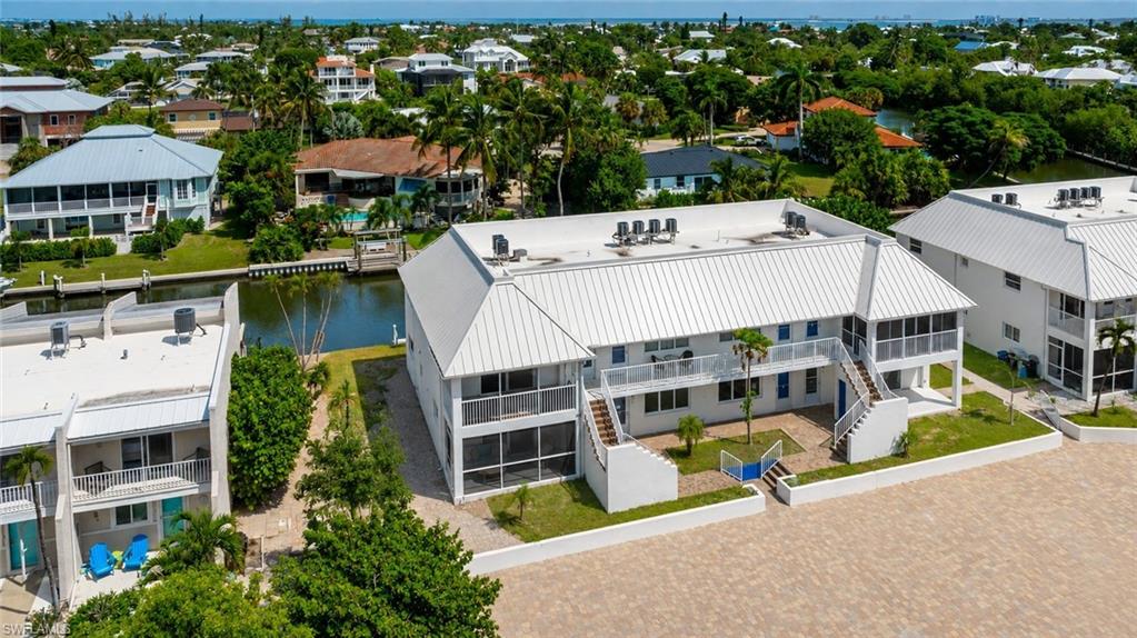 Island living is calling at Sanibel Arms East! This beautifully renovated 2-bedroom, 2-bath first-floor condo offers the perfect combination of beach, boating and laid-back Sanibel living. Ideally positioned along the canal and just across from the beach, this light and bright residence has been completely updated with a fresh coastal feel and is ready to enjoy. Step inside to an open, welcoming interior featuring a brand-new kitchen, beautifully updated bathrooms, luxury vinyl flooring throughout, modern finishes and convenient in-unit laundry. Even better, the building and residence have undergone extensive reconstruction and improvements, including a new roof, impact-resistant windows and doors, new plumbing and electrical, HVAC and water heater—bringing together the charm of Sanibel with the benefits of a beautifully refreshed property. Here, the lifestyle begins right outside your door. Canal dockage makes boating incredibly convenient, while the community boardwalk puts Sanibel’s beautiful white-sand beach and turquoise Gulf waters just steps away. Spend the morning on the boat, the afternoon searching for shells and the evening walking to the beach for a spectacular island sunset. Bring the bikes, too! With convenient access to Sanibel’s extensive bike-path system, you can ride to breakfast, explore island shops and restaurants, visit the Sanibel Lighthouse, catch a show at BIG ARTS or spend the day discovering J.N. “Ding” Darling National Wildlife Refuge before continuing toward Captiva. This isn’t simply a place to stay on Sanibel—it’s a place to experience Sanibel. Beach days, boating, biking, sunsets and time together are all right outside your door. Whether you’re looking for a vacation getaway, an investment property or your own piece of island paradise, this move-in-ready condo at Sanibel Arms East is ready for its next chapter.
