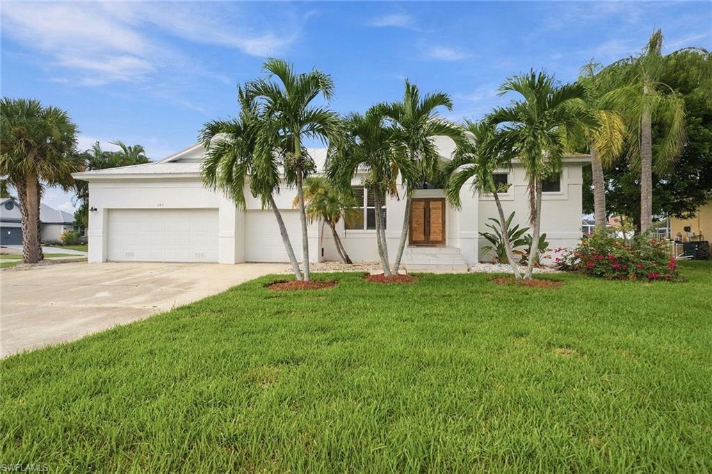 Experience the best of Marco Island’s waterfront lifestyle in this spacious four-bedroom, three-bath residence, ideally on a desirable corner lot with a private boat dock, boat lift, jet ski lift and seawall. Remodeled six years ago, the home showcases elegant French marble flooring, waterproof wood flooring and a roof that is just six years old. Designed for effortless indoor-outdoor living, the residence features a spectacular 3,577-square-foot screened lanai with a pool, spa and outdoor kitchen, creating an exceptional setting for entertaining, relaxing and enjoying the Florida sunshine. A three-car garage, proximity to the beach and excellent rental and investment potential further enhance the appeal of this island retreat. Inside, inviting living spaces blend comfort with distinctive architectural details, including a wood-plank accent wall and custom sliding barn doors in the living room. The updated kitchen serves as a stylish and functional centerpiece, featuring quartz countertops, a stone backsplash, a large center island, wall oven and microwave, pot filler and recessed lighting. A separate dining room provides a dedicated space for gatherings and entertaining. The primary suite offers a spacious closet and an en-suite bath with an oversized shower, creating a comfortable private retreat. Three additional bedrooms provide flexible accommodations for guests, while the thoughtfully designed floor plan supports everyday living and extended stays. Outdoors, the expansive screened lanai becomes a natural extension of the home, offering generous space for poolside lounging, dining and entertaining. The outdoor kitchen adds convenience for hosting, while the pool bath provides easy access from the lanai. A mango tree adds a touch of tropical charm to the property, complementing the relaxed island setting. Boating enthusiasts will appreciate the private dock, boat lift and dedicated jet ski lift, making it easy to embrace Marco Island’s celebrated waterfront lifestyle. Whether enjoyed as a primary residence, seasonal escape or income-producing rental property, this home offers an appealing combination of generous living spaces, waterfront amenities and outdoor entertaining opportunities. Conveniently near Marco Island’s beaches, dining, shopping and recreational attractions, it presents an exceptional opportunity to enjoy the relaxed sophistication of Southwest Florida coastal living.