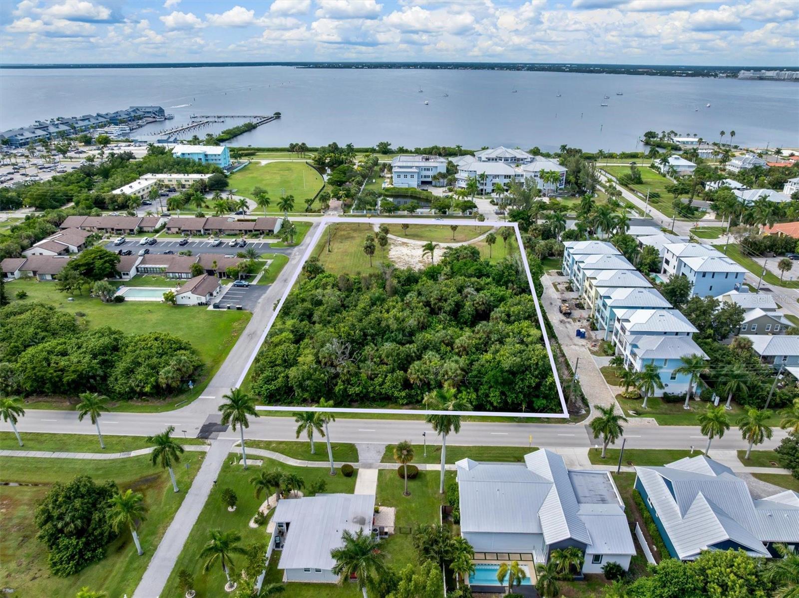 Nearly two acres near Fishermen's Village and Gilchrist Park. This 1.99-acre residential development site is located across from the Military Heritage Museum, placing waterfront dining, shopping, and Charlotte Harbor's shoreline close to a future residential project.

The offering combines 925 W Marion Ave and 960 W Olympia Ave for a total of 86,591 square feet within the City of Punta Gorda. The site extends from W Marion Avenue to W Olympia Avenue, with approximately 208 feet of frontage on Marion, 420 feet on Pittman Street, and 205 feet on Olympia. City water, city sewer, and electricity are available at the street.

NR-15 zoning permits single-family detached homes, duplexes, and multifamily homes, with a maximum density of 15 dwelling units per acre. Final unit count and site design are subject to applicable City development standards and approvals.

For developers and investors, the location offers an opportunity to plan housing around nearby amenities. Future residents could enjoy dining at Fishermen's Village, a nearby wine and coffee bar, the harborfront at Gilchrist Park, and the Harborwalk. Both parcels are included in the sale and offered only as a package. Seller financing is available.