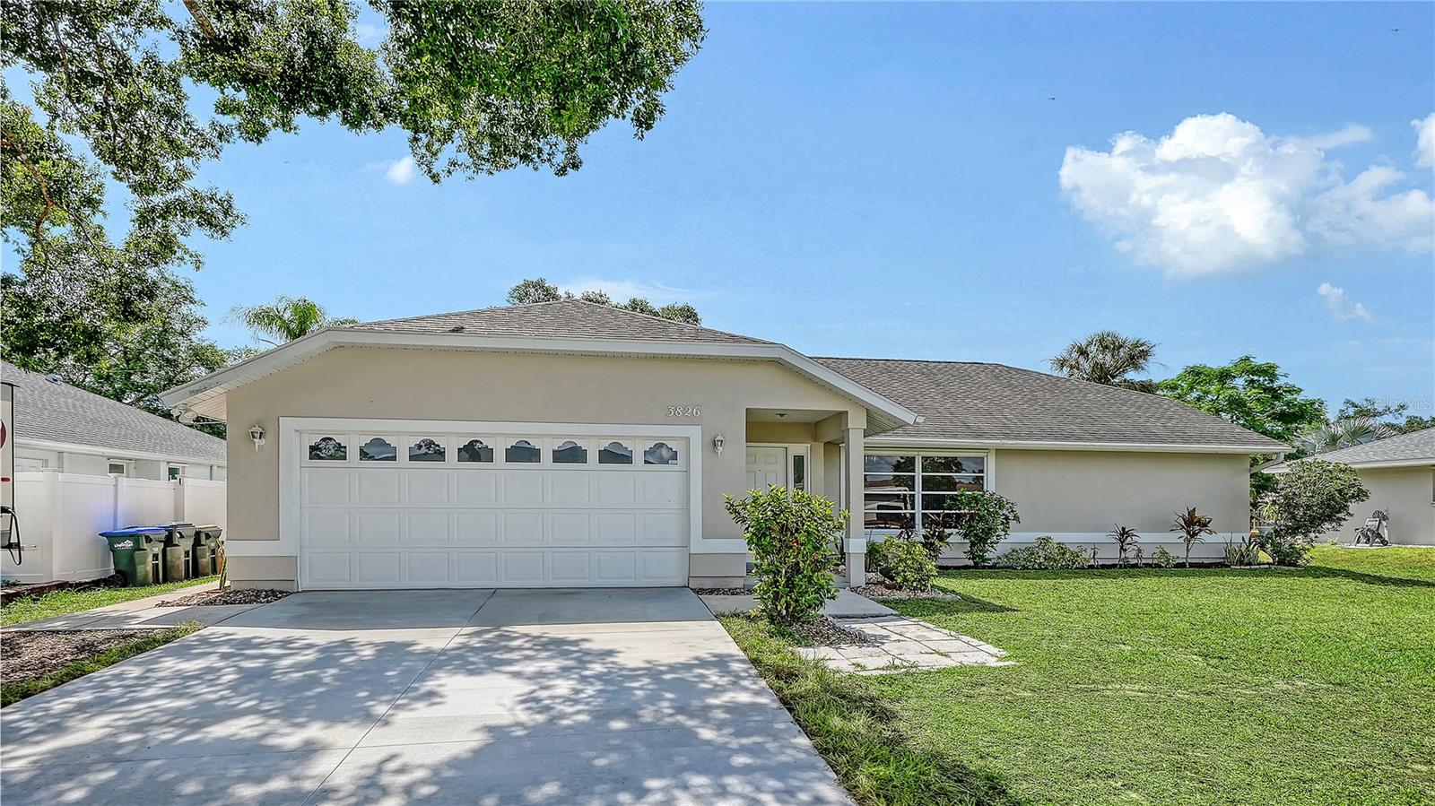 This beautifully refreshed 3-bedroom, 2-bathroom home spans 1,491 sq. ft., this residence offers an inviting atmosphere and peace of mind with significant recent upgrades. Move right in and enjoy a home that feels like new! The property has been freshly painted inside and out, including the garage, giving it a crisp, clean aesthetic. Functional updates abound, including new toilets, a new washer and dryer, side garage door (impact) and a brand-new driveway that enhances the home’s curb appeal. New a/c in 2023. The heart of the home features soaring cathedral ceilings in the primary bedroom, living room, and kitchen, creating an airy, expansive feel. The highly desirable split floor plan ensures maximum privacy, separating the primary retreat from the guest bedrooms—making it ideal for families or those who love to host. Efficiency & Location Enjoy long-term comfort with a new A/C system installed in November 2023. Situated in a great central location, you are just minutes away from local shopping, dining, and major transit routes, putting everything you need within easy reach.