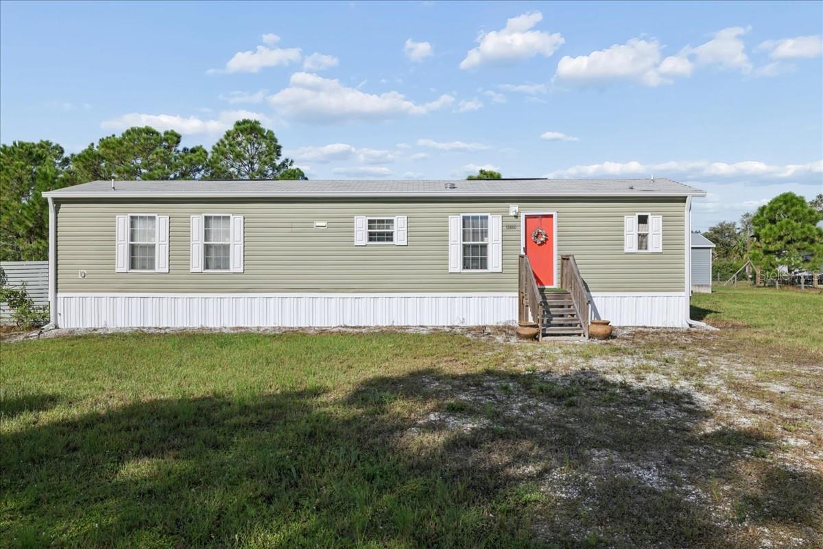 COUNTRY LIVING, PRIVACY & ROOM FOR YOUR TOYS! Discover this charming 2023 manufactured home situated on 1.25 FULLY FENCED ACRES in Punta Gorda's Charlotte Ranchettes! This 2-bedroom, 2-bath home features approximately 840 square feet of comfortable living space and plenty of room to enjoy the Florida lifestyle. A standout feature is the approximately 10' x 16' DETACHED SHED WITH ELECTRICITY, featuring both a traditional entry door and a convenient ROLL-UP DOOR—ideal for storing recreational toys, lawn equipment, or creating an organized hobby space! The home also features an INSTALLED OUTDOOR GENERATOR CONNECTION for added convenience during power outages. Enjoy the peace and privacy of country living while remaining within driving distance of downtown Punta Gorda, shopping, dining, boating, fishing, and outdoor recreation. Southwest Florida's BEAUTIFUL GULF COAST BEACHES, including Englewood Beach and Boca Grande, provides opportunities for sandy shores, spectacular sunsets, and coastal adventures. Travel is convenient with access to both PUNTA GORDA AIRPORT (PGD) and SOUTHWEST FLORIDA INTERNATIONAL AIRPORT (RSW) in Fort Myers. Whether you're seeking a year-round residence, seasonal getaway, or peaceful retreat with room to spread out, this property offers exciting possibilities. DON'T MISS THIS OPPORTUNITY—SCHEDULE YOUR PRIVATE SHOWING TODAY!