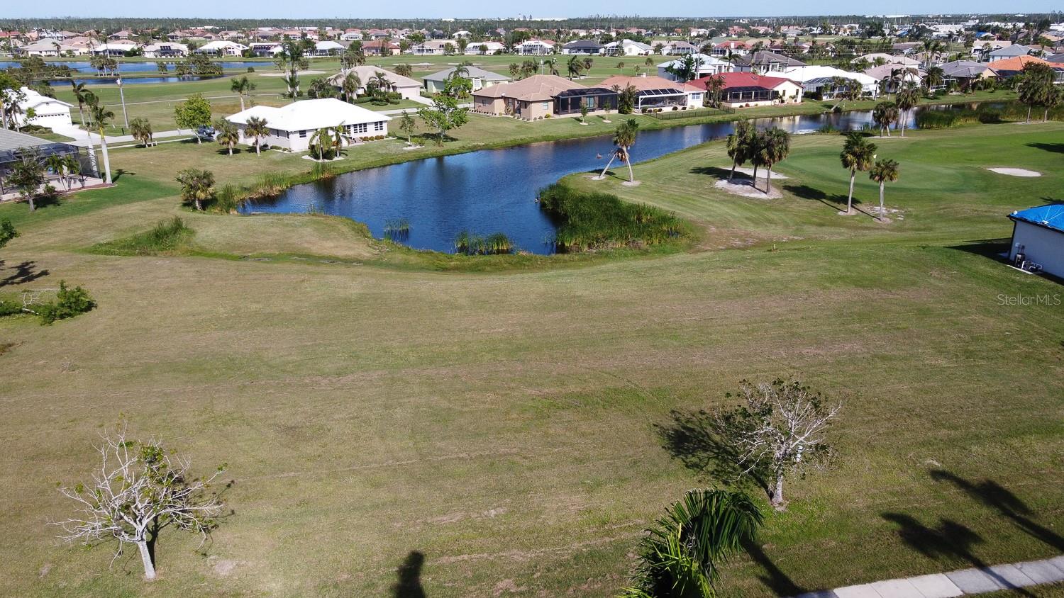 GOLF COURSE/WATER VIEW LOT in Deed Restricted Burnt Store Isles! This highly desirable location borders the golf course, featuring scenic waterfront directly behind. The beauty of this lot is enhanced with plenty of local wildlife, including ducks, cranes, herons, ibis, cormorants and much more. Area residents are eligible for membership in the Twin Isles Country Club, a short walk away, with 18 holes of golf, tennis courts, a swimming pool, a fine restaurant and many community activities. Burnt Store Isles has very little vacant land remaining, this may be your one of your last chances! There are no mandatory HOA fees, membership in the Burnt Store Isles Association is optional at $50. Just 2 blocks away is the convenience of a Publix Shopping Center and Home Depot. Walmart is just minutes away and downtown Punta Gorda is just 5 minutes away with all the histororical sites to visit, the miles long walking trail along the Charlotte Harbor, pickleball courts all over town and so much more. A variety of dining places such as the local pub, sports bars and fine dining with multiple different cuisines to choose from. For all you golfing enthusiasts, there are 8 different golf courses within a 20 minute drive. The park on the Charlotte harbor is spectacular and then our local traditions such as the Saturday morning farmers market, always a fan favorite, and then the Christmas Tree lighting block party and of course a massive Halloween experience. So walk the lot and imagine building your dream home right here in Burnt Store Isles!