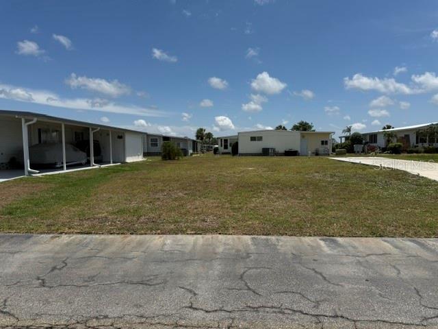 Imagine the possibilities with this lovely vacant lot, with concrete driveway in place, located near La Casa Recreation Hall, our large pool, and many other amenities. The property offers the ideal blend of tranquility and accessibility. Welcome to La Casa, an enchanting community where 974 homesites are beautifully set among native trees and surrounded by spacious common grounds and eight serene lakes. La Casa is conveniently located between Sarasota and Fort Myers with easy access to shopping, sightseeing, golfing, fishing, and our beautiful Suncoast beaches. La Casa is a friendly, family-oriented haven where you can enjoy tranquility while remaining close to vibrant attractions. Come visit our charming oasis and discover why La Casa is the ultimate destination for snowbirds and year-round residents!