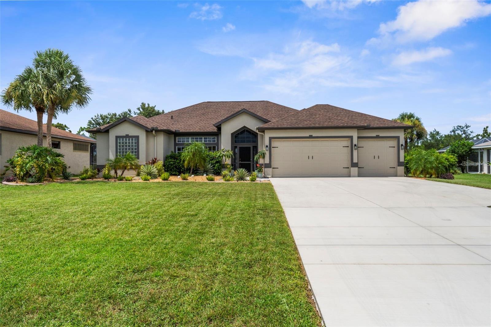 SHOWINGS BEGIN 10/31. So many things to love about this house! As you approach the home, you'll notice that it sits well off the road, which allows for a long driveway with ample parking. You'll enter the front door and be greeted by an open, airy space with a wall of sliders which provide a peaceful view out to the lanai, pool, hot tub and large fenced yard. The primary bedroom and en suite bath are to the left, and have sliders out to the lanai. On the other side of the house, you'll find the other 2 bedrooms, one of which is enormous with TWO walk in closets. The other bedroom has one walk in closet and sliders to the lanai. The hall bathroom, which also has access to the lanai, was recently updated with a walk in shower, glass door and accent wall for a spa like experience. The 3 car garage is oversized with a bump out in the back which would be an idea space for a workbench, freezer or storage. The garage also offers epoxy flooring and TWO closets for extra storage. Landscaping and new curbing was completed within the last year. You'll be proud to call this one yours!