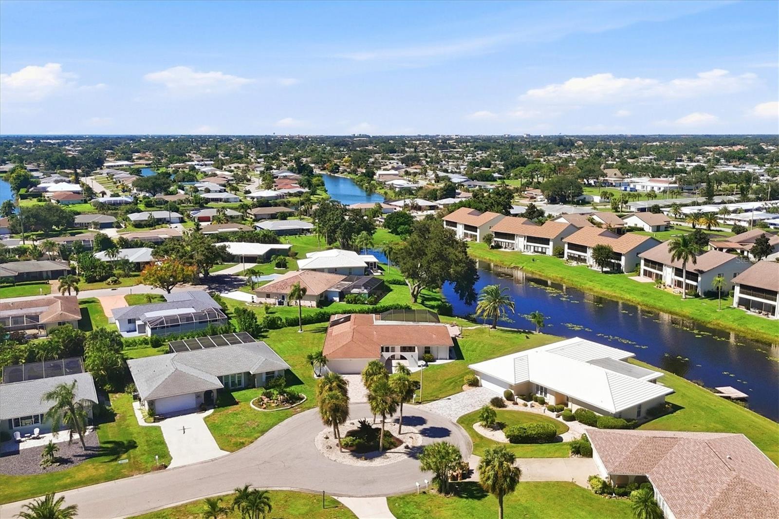 Discover an exceptional waterfront retreat in the established and desirable community of Venice Gardens adjacent to Jacaranda West, where tranquil surroundings, picturesque lake views and effortless Florida living come together. Privately at the end of a peaceful cul-de-sac, this beautifully maintained three-bedroom, three-bath residence enjoys captivating wraparound views of Claw Lake and an expansive home site encompassing nearly one-third of an acre. A welcoming paver driveway and elegant arched courtyard entry introduce a thoughtfully designed residence offering a spacious, inviting floor plan ideal for everyday comfort and gracious entertaining. Tile and laminate flooring flow throughout the home, providing an appealing, low-maintenance interior. At the heart of the residence, the beautifully updated eat-in kitchen features abundant rich wood cabinetry, granite countertops, a coordinated suite of stainless steel appliances and a convenient pass-through serving bar connecting seamlessly to the outdoor entertaining area. Embrace the quintessential Florida lifestyle in your private outdoor sanctuary, where a heated swimming pool, screened enclosure and multiple covered seating areas create an inviting setting for year-round enjoyment. Whether hosting intimate gatherings, enjoying morning coffee overlooking the lake, or unwinding beneath the evening sky, this exceptional space offers a beautiful connection to its natural surroundings. A charming paver walkway leads toward the water's edge, where fishing, bird watching and serene lakefront moments become part of everyday life. Herons, egrets and osprey frequently grace the picturesque landscape, enhancing the property's peaceful ambiance. Centrally in Venice, residents will appreciate the nearby Jacaranda West Country Club membership options, featuring an award-winning 18-hole championship golf course, tennis facilities, practice areas, clubhouse dining, and a variety of golf and social activities. The Venice Gardens Civic Association offers additional recreational opportunities through optional membership, including a community swimming pool, water aerobics, exercise classes, social gatherings, and community events. Together, these nearby amenities enhance the relaxed yet active Gulf Coast lifestyle. With low homeowners association fees and a desirable location, this residence places you within easy reach of Venice's beautiful Gulf beaches, the boutiques and restaurants of historic downtown Venice, the vibrant dining and entertainment destinations of Wellen Park, and an abundance of shopping, recreation and cultural attractions. Living the life you’ve earned can be more than just a dream.