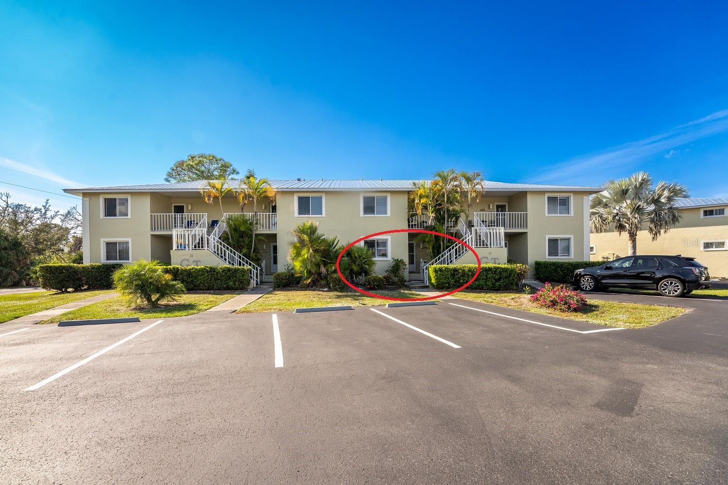 This is a "hidden gem" of a condo community!  No need to climb stairs! This much sought after main floor condo at Golden Tee, a popular "over 55" community, backs onto Wildflower Preserve, with a second Environmental Park at the end of the quiet dead end street. Dine on the screened and vinyl enclosed lanai while taking in the sunset, or curl up with a good book. Become part of a welcoming "over-55" community which offers many activities, from golf, tennis, pickleball - to euchre, bingo, trivia nights, and regular social gatherings. Relax in the beautiful heated pool or take a short drive to the beaches on Boca Grande.<br> This condo is being sold turnkey furnished! The well equipped kitchen features an updated kitchen w/new cottage style cabinetry & quartz countertops. Both the Whirlpool microwave and range are new, the refrigerator is about a year old, and the LG dishwasher is newer. Cabinets under the breakfast bar provide additional storage! The open, inviting living/dining area features easy to maintain NEW laminate floors and glass sliding doors to the lanai. The primary bedroom has NEW laminate flooring, a walk-in closet and another set of sliding glass doors opening onto the lanai. The "en suite" bath has been beautifully redone and features a new vanity w/quartz countertop, new lighted mirror and medicine cabinet, plus step in shower with door. The roomy guest bedroom has new laminate flooring and a large wall closet. The guest bath has been updated with a new vanity w/quartz countertop, new toilet, new stylish mirror w/lighting all around, new medicine cabinet, and resurfaced tub/shower combo. The laundry closet houses a full size washer and dryer. Both bedrooms as well as the living room have overhead fans. Metal roof was replaced in 2021 and AC system in 2024! This condo association has maintained consistently low association fees and is professionally managed. <br>Why continue to shovel snow up north when you can bask in the Florida sunshine? Come on down!