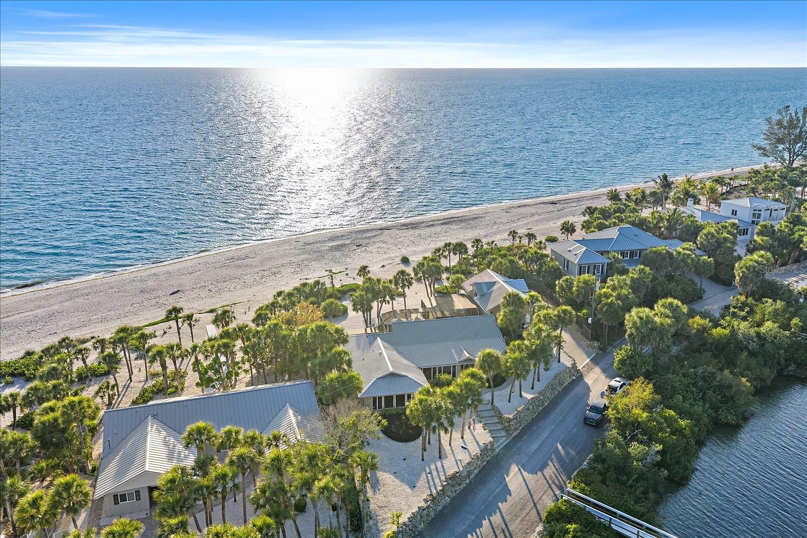 A rare, irreplaceable Gulf-to-Bay legacy compound situated on the private, gated north end of North Manasota Key: 756 North Manasota Key Road commands an extraordinary coastal position spanning from 155 feet of private Gulf of Mexico beach frontage to 155 feet of protected deep-water dockage on Lemon Bay. 

Cherished by the same family for nearly three decades, this compound-sized parcel captures both glowing bay sunrises and vibrant Gulf sunsets across nearly 300 feet of pristine depth. Anchored by an exceptional 12.9-foot site elevation and comprehensive capital infrastructure—including a 2021 metal roof, three updated HVAC units, modern PVC plumbing, a 2016 septic system, a 2025 pool cage, and selected impact-rated openings within a fully fenced perimeter—this estate delivers rare barrier island peace of mind.

Offering 4,033 square feet of living area, the property is thoughtfully configured for multi-generational living or refined host-guest separation. The main residence features 3 bedrooms, 3 full baths, soaring cathedral ceilings with rich cypress accents, custom millwork, integrated surround sound, and Andersen windows framing sweeping water views. At its center, the chef’s kitchen is appointed with solid wood cabinetry, dual pantries, a Thermador cooktop, and GE Monogram appliances that look directly out over Lemon Bay. Providing ultimate privacy, a self-contained 2-bedroom guest apartment with its own dedicated living room is set above the garage.

Outdoor living is engineered for world-class recreation. Step from the main living area to the heated screened pool and an expansive 18x48 open lanai just strides from the sand, or walk to the protected bay side to your private 89-foot deep-water dock—newly re-decked in 2025 and equipped with power, water, and a cleaning station. 

Boating is effortless with sheltered mooring on Lemon Bay and bridge-free navigation through Stump Pass straight into the Gulf, as well as easy cruising to local waterfront dining. Whether enjoyed immediately as an authentic coastal sanctuary or reimagined into an architectural showpiece, opportunities pairing this caliber of dual frontage, high elevation, and seclusion are virtually impossible to replicate. 

Contact the listing team directly to request the complete property dossier or arrange a private, confidential tour.