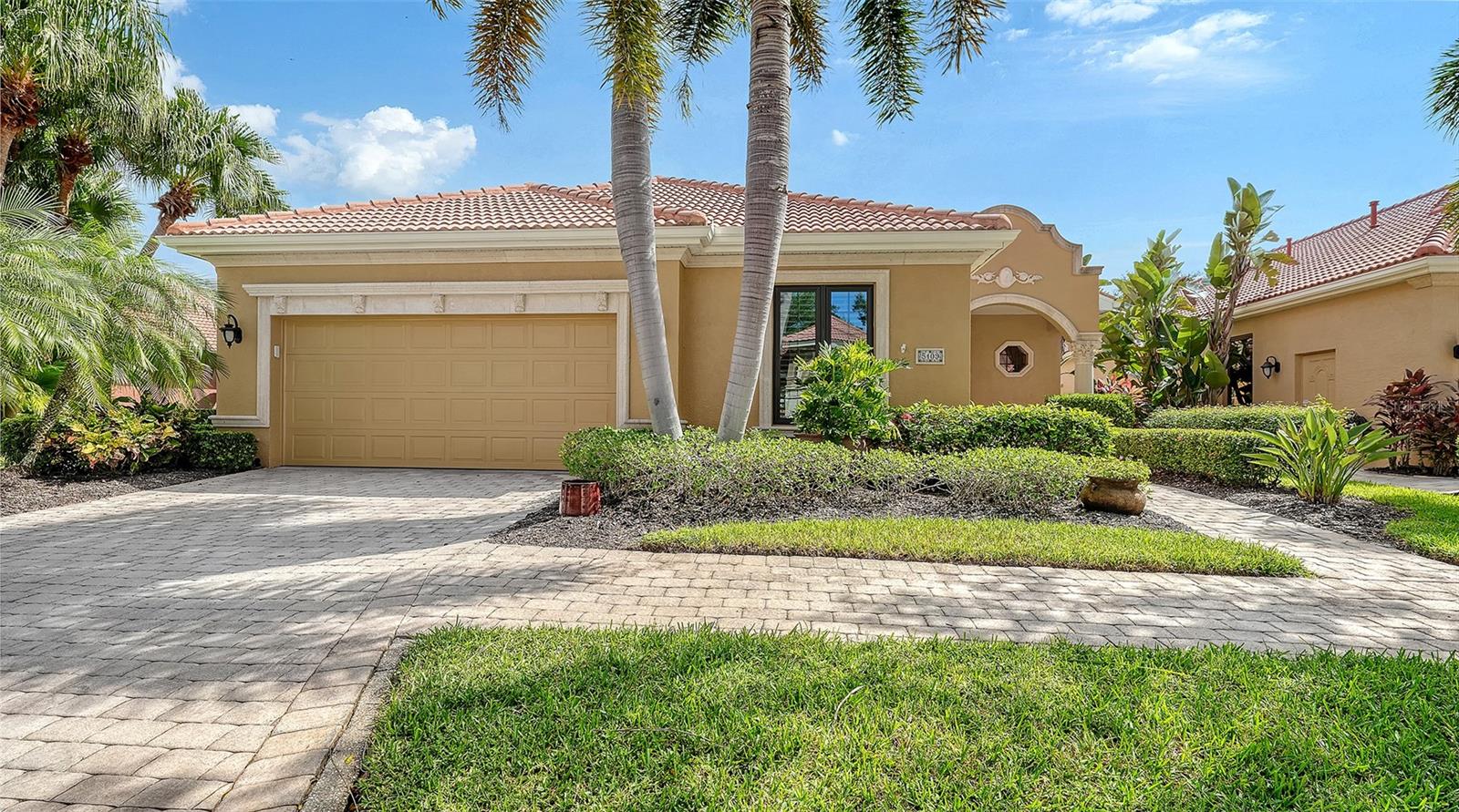 This unique and finely appointed lakefront pool home located in the gated community of the Vineyards at Silver Oak is without rival. From the moment you step foot through the threshold of the front door you are treated to view a chic and highly updated maintenance-free home set in the heart of Palmer Ranch. Looking for an established community, a tasteful layout, and modern conveniences such impact glass windows and sliding doors, a newer tile roof (2023), and newer HVAC system (2023)- Look no further! The main living area of this home is trimmed with engineered hardwood, crown molding, plantation shutters, tray ceilings, enhanced architectural trim, custom built-ins and much more.  The recently renovated kitchen area features quartzite countertops, 36 inch natural gas range, incredible custom wood built-in with SubZero wine refrigeration, stainless steel appliances, quartzite backsplash, and custom island.  The main living area features a generously sized great room, built-in gas fireplace, formal dining room with skylight, family room with views of the pool and many more fine details.  The primary suite is well adorned with dual walk-in closets with built-ins, bay windows sliding glass door access to the pool, and a spa-like bath with dual vanities, Jacuzzi tub, and walk-in shower. The second bedroom area converts into a guest suite with closing door, en-suite bathroom and spacious closet. The third bedroom also features and ensuite bathroom and ample storage.  Moving to the backyard makes this home shine even more- the long eastern lake views overlooks trees, a fountain, and your own heated pool.  There is a large, covered lanai for sitting and listening to music through the built-in speakers.  The Vineyards features a generous amenity area complete with heated pool, fitness room, meeting area, and kitchen.  Silver Oak, one of the finest communities in Palmer Ranch features a 24 hour a day manned gate, private roads, and a maintenance-free lifestyle in the Vineyards.  The comforts of shopping at Costco, Publix and other retailers are just a short drive away, and the community boasts easy access the Legacy Trail and Gulf Beaches.  This is a true standout property- schedule your private showing today !