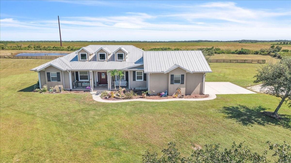 Welcome home to 18150 Bending Willow Court, located in the desirable, horse-friendly Prairie Creek community of Punta Gorda! Situated on over 5 acres, this custom-built home offers the space, privacy, and peaceful setting that make acreage living so special. With 4 bedrooms, 2 additional office or den spaces, 2 1/2 baths and a spacious 3-car garage, there is plenty of room for everyone!

As you step inside, you'll find a warm and inviting home filled with custom details throughout. The spacious kitchen features solid wood cabinetry, granite countertops, a walk-in pantry, and an oversized breakfast bar, offering plenty of room for cooking and gathering with family and friends. Additional features include a metal roof, hurricane-impact windows and doors, providing added peace of mind.

Step outside and enjoy your own private Florida retreat! The saltwater pool is perfect for relaxing or entertaining, complete with a recently replaced pool pump. Beyond the pool, you'll find a peaceful pond and beautiful open land with plenty of room to enjoy the outdoors. The fully fenced property, complete with a gated entrance, offers added privacy and endless possibilities for those looking to make the most of acreage living.

Located in the sought-after Prairie Creek community, known for its large homesites, quiet surroundings, and horse-friendly atmosphere, this property offers the best of country living without giving up convenience. You're just a short drive from Punta Gorda's shopping, dining, Fishermen's Village, and beautiful waterfront attractions. Plus, the property is located in an area where flood insurance is not required by most lenders, making this acreage retreat even more appealing.

Come experience the space, privacy, and lifestyle this beautiful property has to offer. Schedule your own personal tour today!
