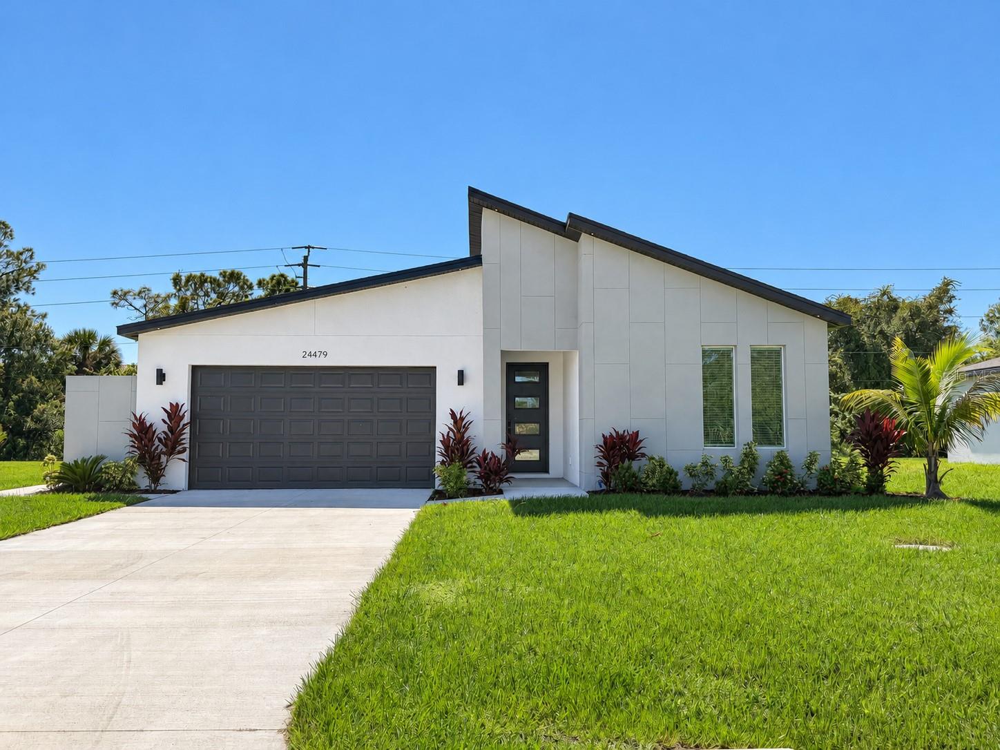 Highest and Best Offers Due by November 1st!

Modern lines, black accents and a kitchen that brings everyone together. This never-occupied, four-bedroom, two-bath home offers 1,931 square feet of living space with an open layout and tile flooring throughout. White cabinetry, stainless steel appliances and a waterfall island anchor the kitchen, while tray ceilings with accent lighting add character to the entry, living room and primary bedroom. The primary suite includes a double vanity and a glass-enclosed shower with contrasting tile and black fixtures. Sliding doors open to a covered patio and backyard. An indoor laundry room, two-car garage and approximately 0.24-acre lot round out the home. Completed new construction with a one-year builder warranty. Located in The Links with public water and sewer and no HOA or CDD.