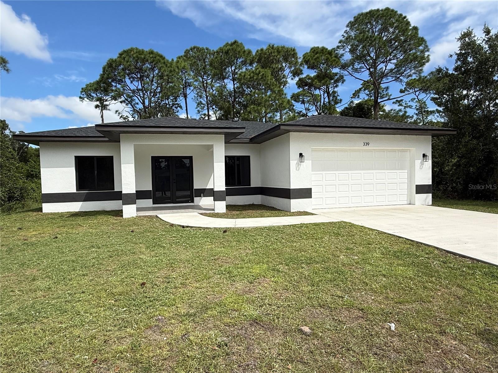 Here is your opportunity to own a brand-new construction 3/2 home in Sebring. This modern home features an open living space with impact resistant windows and doors. The Kitchen layout wraps around a beautiful quartz countertop, island with front and side seating area, built-in microwave
and extra cabinet storage. Stainless steel appliances, electric cooktop with stylish hood and tiled backsplash making this classic
Kitchen sparkle! A Covered Lanai gives this airy home with ample outdoor entertaining space. The master suite offers a convenient
walk-in closet, before the amazing bathroom with double sink vanity, toilet room and sturdy glass door in the shower space. The
other two bedrooms have a good natural light and decent closet space. Plenty storage space around the house, including a pantry.
Large laundry room. The full size 2 car Garage affords additional storage
space because HVAC unit is elevated . This house is ready to have a new owner! No HOA, No CDDs!