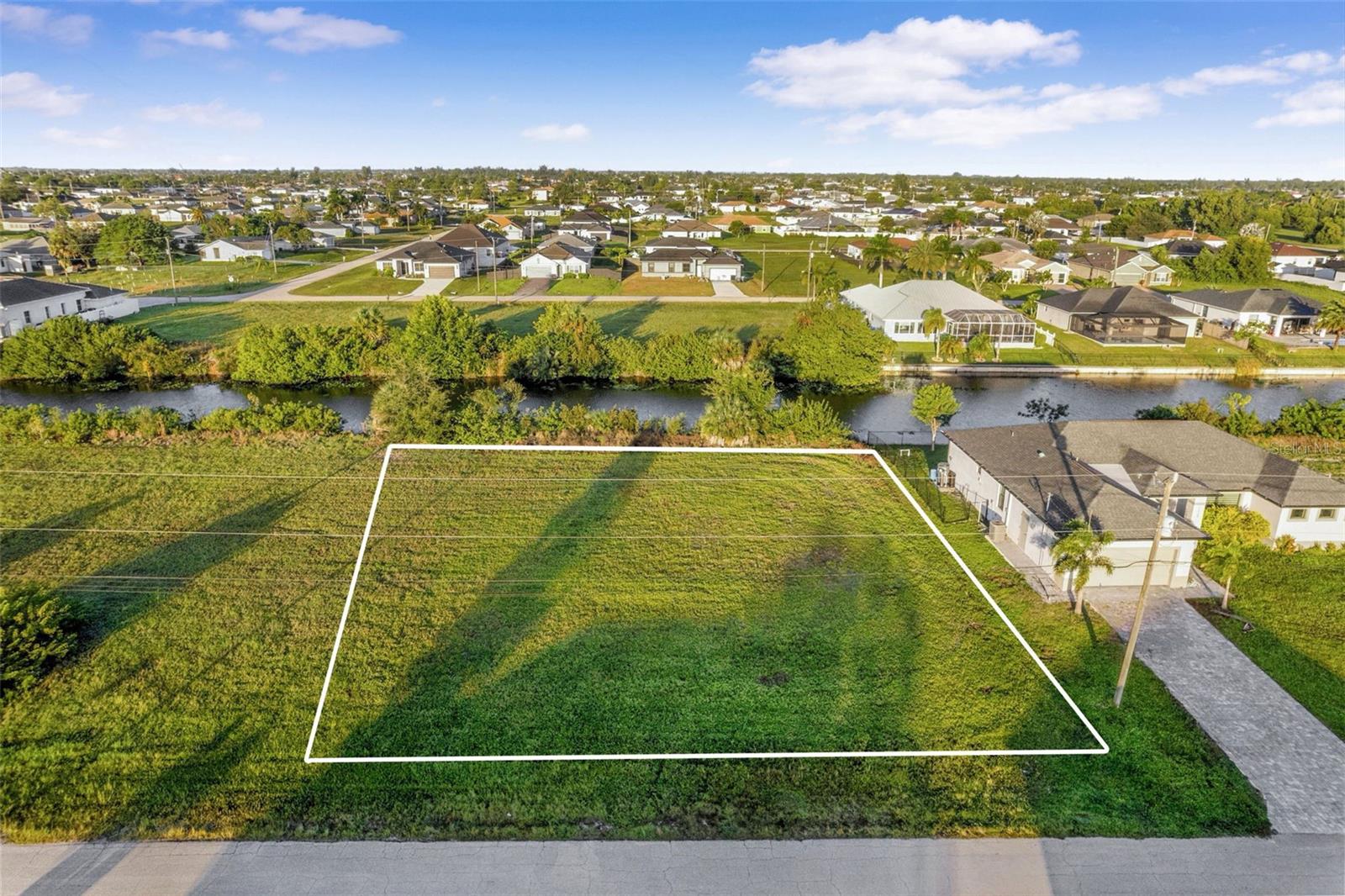 Build your DREAM HOME at 1324 NW 13th Place, Cape Coral, Florida. With a GENEROUS size lot containing just under 1/4 acre with dimensions 80' wide by 125' deep of level land in Lee County, you can design your MAGNIFICENT WATERFRONT OASIS. This FRESHWATER, CANAL-FRONT LAND connects to Anchor Lake & more nearby lakes through the connected canals. This plot is zoned residential whose purpose is designed to encourage and protect single-family development within the county. The land features SUPERB ACCESS with paved roads. BONUS: This land has already been cleared. Of course, the buyer is encouraged to verify with the county & other professionals regarding building codes, zoning & whatever else is deemed necessary in order to make an informed decision. Watch birds & other wildlife from your own property or cast your fishing line right from your backyard to catch dinner. As the backyard faces WEST, enjoy daily SUNSETS paint the sky in VIBRANT COLORS. Shopping centers, schools, medical plazas, places of worship, restaurants, gorgeous beaches, lakes, parks & tourist attractions are only a short drive away. Enjoy the many festivities & events in nearby DOWNTOWN CAPE CORAL that the BUSTLING city has to offer. New home construction is BOOMING! Build your PRIVATE GETAWAY in this NO HOA, NO CDD, NO FLOOD zone where you can store all your vehicles from RVs to jet skis to boats to everyday vehicles. Where else can you find such a large piece of tropical, waterfront vacant land with 10,019 sqft in such close proximity to the open gulf at this give-away price? Drive by & explore the property, check out the detailed pictures, walk the virtual tour using Google maps & then call your favorite Realtor to make an offer. MAKE THIS YOUR FUTURE HOME!