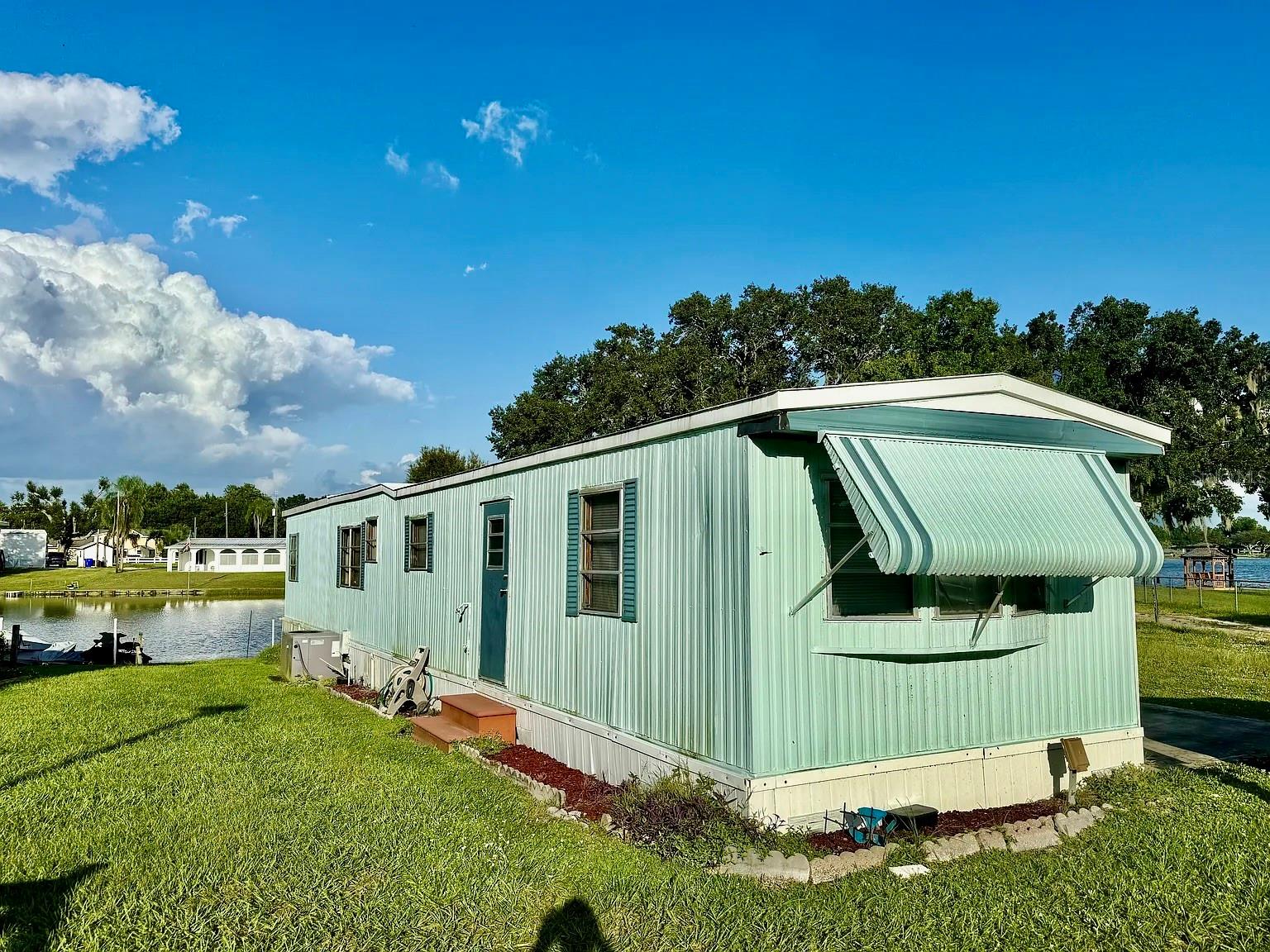 Owner Financing available at 5% interest with 3-5 year term with 25% down! Fully Furnished Waterfront Home on Lake Grassy! Don't miss this rare opportunity to own a turn-key waterfront retreat in the highly sought-after Lake Placid area. Whether you're looking for a full-time residence, weekend escape, or investment property, this charming 2-bedroom, 1-bath home offers the perfect blend of comfort, convenience, and Florida lakefront living. Bring your boats, Jet Skis, fishing poles, and sense of adventure, and start enjoying everything this exceptional property has to offer.

Nestled along a peaceful lagoon with direct canal access to beautiful Lake Grassy, this home is perfectly positioned for boating, fishing, kayaking, or simply relaxing while taking in the tranquil waterfront views. Inside, you'll find a spacious living area filled with natural light, featuring sliding glass doors that create a seamless connection between indoor and outdoor living.

The generously sized primary bedroom offers a walk-in closet along with built-in cabinetry that provides an abundance of storage. The bathroom is thoughtfully designed with dual vanities and a walk-in shower for added comfort and convenience. The kitchen overlooks the lagoon, making meal preparation a pleasure while enjoying the scenic water views. A convenient pass-through opens to the living area, while the adjacent dining space creates an inviting setting for everyday living and entertaining family and friends.

Step outside and experience everything waterfront living has to offer. The sale includes two floating Jet Ski docks and a floating boat dock, making it easy to launch your next day on the water. Additional exterior features include a screened-in front porch, a rear patio overlooking the lagoon, extra storage on the back side of the home, ample parking, and an additional area directly across from the home that is perfect for storing trailers, boats, or recreational vehicles.

Additional highlights include central air conditioning, portable A/C units in each bedroom and the addition/living area for enhanced comfort, and an incredibly affordable HOA fee of just $105 per quarter, which includes community water service.

Located in a welcoming waterfront community, you'll enjoy being just a short drive from downtown Lake Placid, Lake Istokpoga, Sebring, and world-renowned Lake Okeechobee, offering endless opportunities for recreation, dining, shopping, and some of Florida's best freshwater fishing.

This home is truly move-in ready—simply grab your toothbrush, pack your clothes, and start enjoying the Florida waterfront lifestyle you've been dreaming of. Schedule your private showing today before this exceptional opportunity is gone!