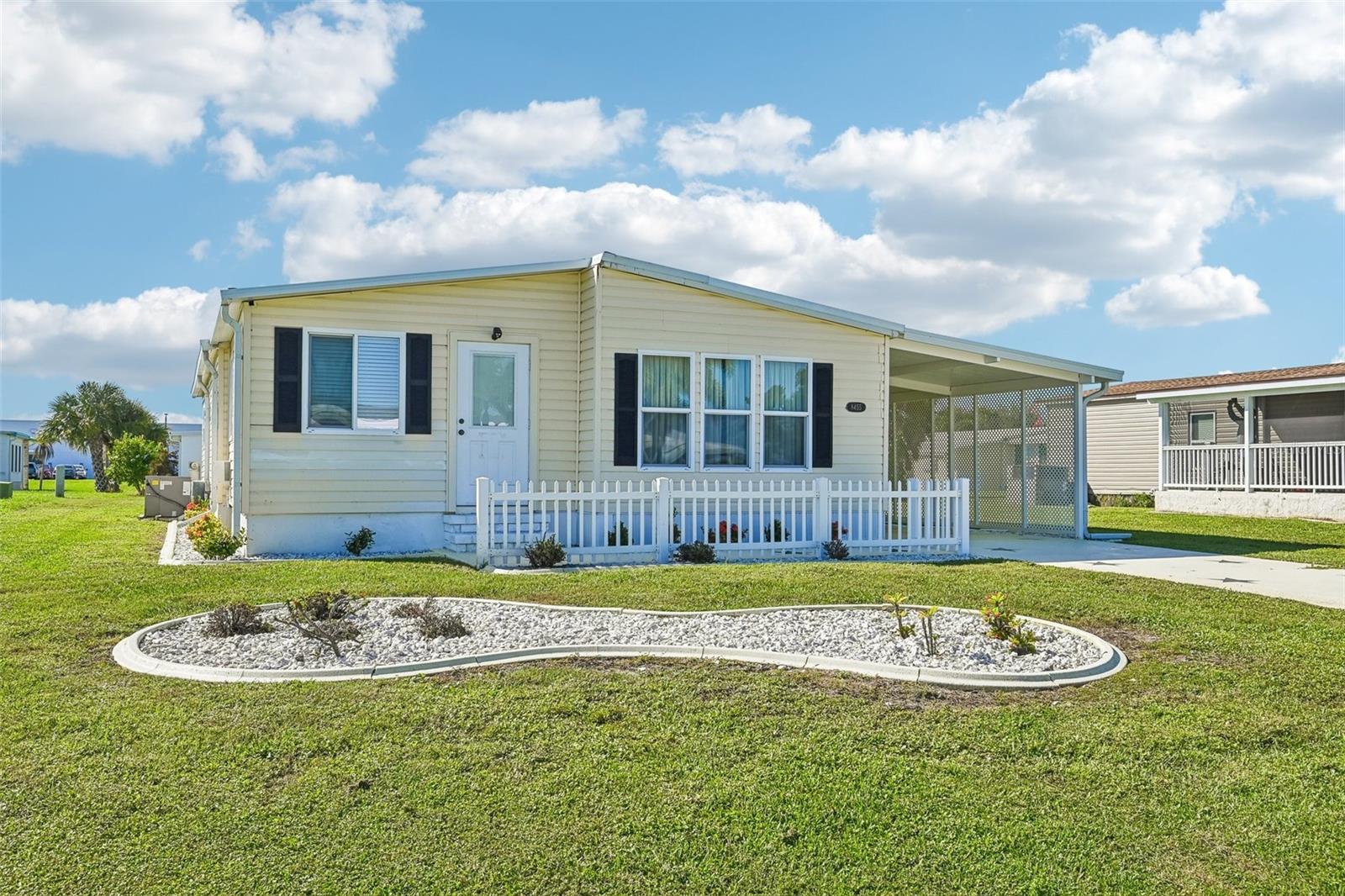 Welcome to your dream Florida retirement! This beautifully updated, turn-key 2-bedroom, 2-bathroom manufactured home is located in the highly desirable, golf-cart-friendly 55+ community of Lemon Bay Isles in Englewood, Florida. Best of all, this is a land-owned property—you own your piece of paradise with absolutely no expensive lot rent! Enjoy financial freedom with a remarkably low annual HOA fee, plus the ultimate flexibility of an optional social club membership (such as the nearby Edgewater Club) for a modest additional fee, granting access to a heated pool, tennis, pickleball, and a vibrant calendar of events only if you choose to join.

Structural Updates & Complete Peace of Mind

• Brand-New Roof: Currently being completely redone and will feature a 20-year transferable warranty for the ultimate worry-free protection.
• Upgraded Kitchen: Beautifully remodeled with sleek stone countertops and like-new, hardly used appliances.
• Modern Living Space: Step inside to flat, modern sheetrocked ceilings that elevate the entire home's aesthetic.
• Replaced Florida Room: Fully replaced in 2017, offering a bright, sunshine-filled space perfect for morning coffee or relaxing.
• Solid Bones: Rest easy knowing this home is built on a rock-solid foundation with sturdy flooring throughout.

Thoughtful Layout & Exterior Perks

• Carport Parking: Features a convenient, attached covered carport to shield your vehicle from the Florida sun.
• Split-Bedroom Floor Plan: Offers great privacy when hosting guests, featuring two generously sized bedrooms with large closets.
• Outdoor Oasis: A smooth sliding glass door opens up to your private back patio, ideal for grilling or soaking up the coastal breezes.
• Bonus Storage & Laundry: The exterior utility shed houses your laundry setup, plenty of storage space, and includes a heavy-duty tool cabinet to kickstart your hobbies.
Located just minutes from gorgeous Englewood and Manasota Key beaches, local boat ramps, dining, and shopping, this turn-key home delivers the ultimate affordable coastal lifestyle. Schedule your private showing today!