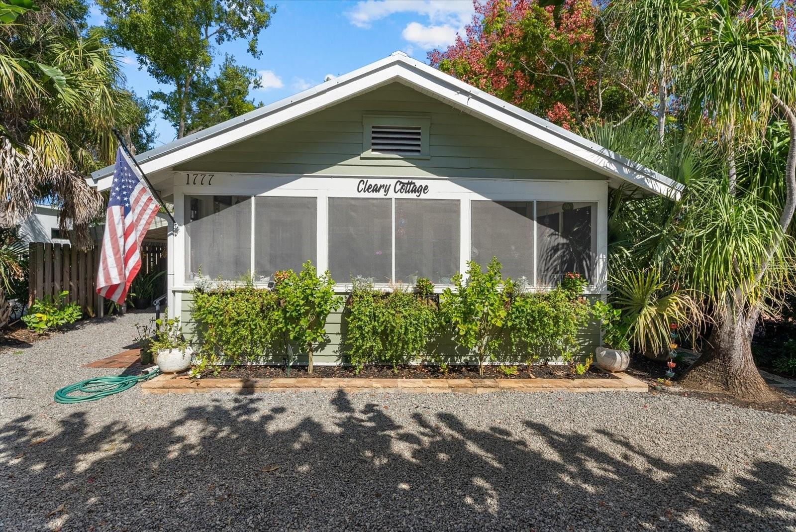 Virtually Staged. Welcome to Cleary Cottage, a charming 1935 bungalow nestled in the highly sought-after Hudson Bayou neighborhood, West of Trail in the heart of Sarasota. Blending timeless character with thoughtful modern updates, this beautifully maintained 3-bedroom, 2-bath residence offers an inviting retreat just minutes from downtown Sarasota, Southside Village, Sarasota Memorial Hospital, Selby Gardens, the bayfront, and the area's renowned beaches. From the moment you arrive, the lush tropical landscaping, circular driveway, and welcoming screened front porch set the tone for this distinctive home. Inside, original hardwood floors, plaster walls, crown molding, and a classic brick fireplace celebrate the home's historic charm, while an updated kitchen featuring white cabinetry, stone-look countertops, stainless steel appliances, and tasteful finishes provides modern convenience. The comfortable floor plan offers inviting living and dining spaces, three bedrooms, and two updated bathrooms, including a primary bath with a beautifully tiled walk-in shower. A metal roof installed in 2018, an updated HVAC system, and hurricane protection improvements add to the home's appeal. Step outside to discover a private tropical oasis with mature landscaping, a backyard deck, and inviting outdoor spaces ideal for relaxing, entertaining, or enjoying Sarasota's year-round sunshine. The spacious screened front porch, complete with a charming porch swing, offers yet another place to unwind and enjoy the neighborhood. Located in FEMA Flood Zone X, this property offers the added advantage of being outside the designated high-risk flood area. Its location and zoning also create an attractive short-term rental opportunity, offering flexibility for buyers considering seasonal use, part-time occupancy, or income-producing potential. Whether you're searching for a full-time residence, seasonal escape, or a Sarasota property with flexible rental potential, Cleary Cottage delivers a special combination of character, comfort, and location. Experience the charm of Old Florida living with the conveniences of Sarasota's vibrant downtown, shopping, dining, cultural attractions, and world-famous Gulf Coast beaches close by. Schedule your private showing and discover what makes Cleary Cottage so special!