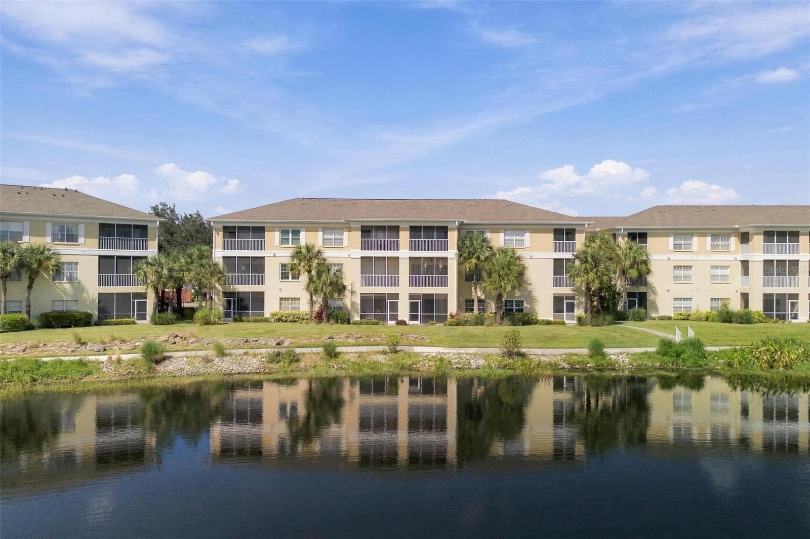 Priced to sell fast! Move right into this first-floor lakefront condo in the popular gated community of Heritage Oak Park. Enjoy a fantastic lake view from the screened lanai. This condo features 2 bedrooms, 2 full baths, interior laundry with a newer 2024 stack washer and dryer, and an open floor plan with a great room and dining area. The split bedrooms, kitchen with breakfast bar, closet pantry, and breakfast nook (including 4 bar stools) make it perfect for comfortable living. The master suite offers a large walk-in closet and a great lake view, while the ensuite master bath has dual sinks and a walk-in shower. Additional highlights include porcelain tile floors in the foyer, kitchen, and baths, brand-new neutral carpet in the great room and bedrooms, freshly painted interior, ceiling fans with lights in the great room and bedrooms, and window treatments throughout. A detached carport (new in 2023) is included, along with a new roof (2021), and A/C heat (2021). Heritage Oak Park is an active gated community in the Murdock area of Port Charlotte, offering a large clubhouse, heated pool, fitness room, billiards, library, tennis courts, pickleball, shuffleboard, bocce ball, and a scenic walking trail around the lake. With a full-time activities director and beautiful old oak trees, it feels like country living yet is within walking distance of Publix, the YMCA, and the Charlotte County Library, and just a short drive to major shopping and restaurants.