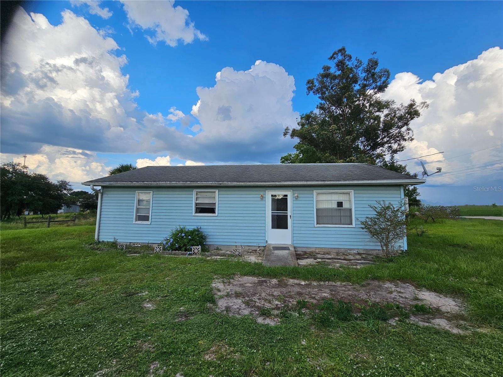 Are you someone with a bit of vision and a love for rural charm? This 3 Bed/2 Bath Wood Home is located on approx. 1/2 Acre on a paved county road waiting for YOU! The home offers a unique opportunity for those ready to add their personal touch. Although it needs TLC, this property is brimming with potential. The spacious lot provides ample room for additions such as a garage, workshop, or garden—perfect for anyone looking to expand their space and enhance their lifestyle. Nestled near the quaint town of Lake Placid, this home allows you to embrace a tranquil, rural lifestyle while enjoying the natural beauty of the area. Lake Placid offers a variety of festivals and events throughout the year, adding a touch of community spirit to your surroundings. Additionally, the nearby town of Sebring hosts the renowned 12 Hours of Sebring race each March, making this location ideal for motorsports enthusiasts. Whether you're into fishing, relaxing by the lake, or exploring the charm of Highlands County, this home provides a wonderful backdrop for all that this region has available. Don’t miss the chance to make this house your own, check it out!