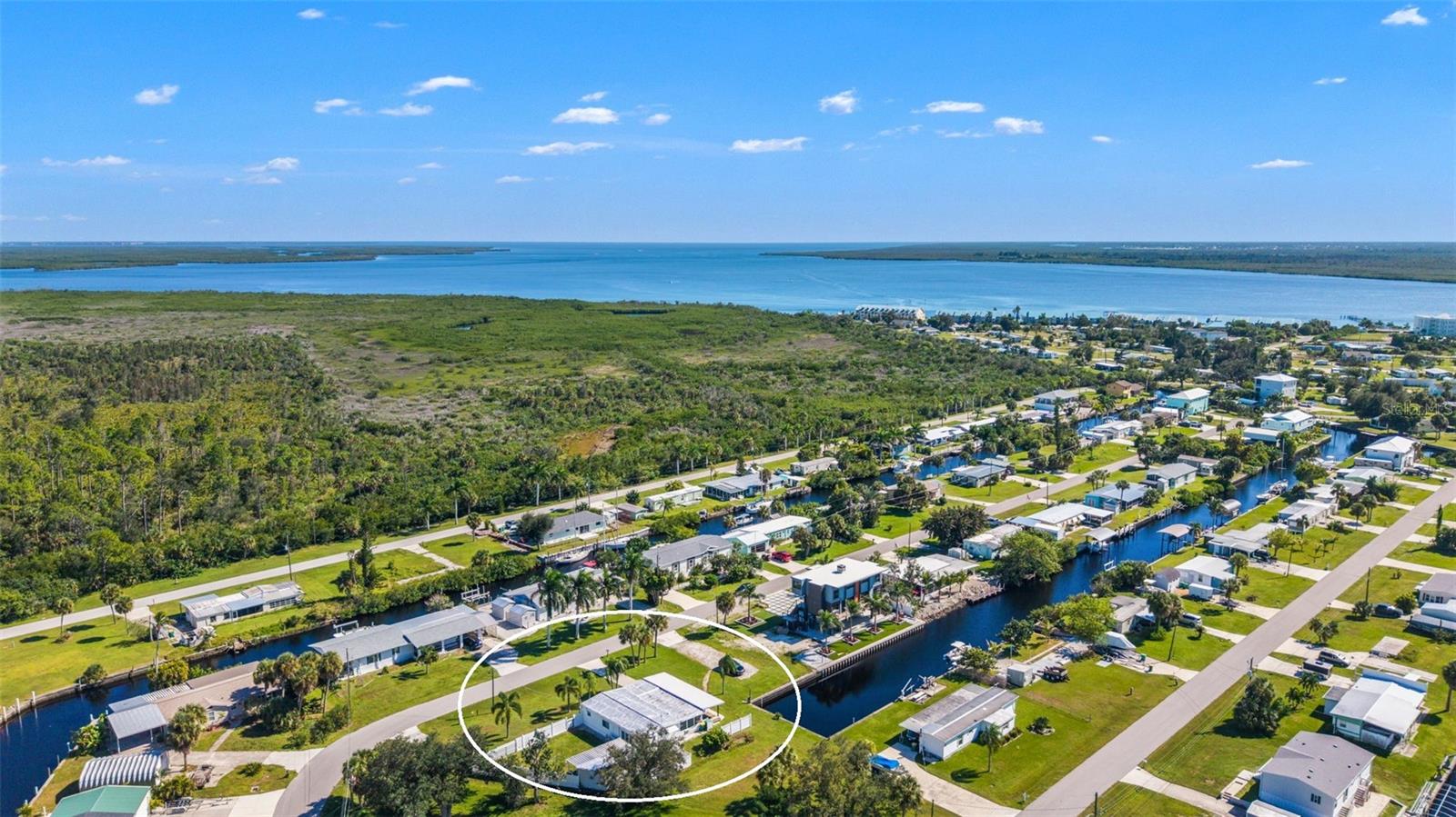 A Rare Waterfront Opportunity in Historic El Jobean – Three Lots on Sailboat Water with Direct Gulf Access! A charming Old Florida waterfront community along the Myakka River, this unique property offers an opportunity to enjoy the area's rich history, relaxed coastal atmosphere, and exceptional boating lifestyle. Situated on three lots along sailboat water with direct access to Charlotte Harbor and the Gulf of Mexico, this property offers far more than just a place to call home.

Inside, the thoughtfully updated 2-bedroom, 2-bath home offers a surprisingly spacious feel, thanks to two distinct living areas that provide room to spread out, relax, and entertain. The main living space features an inviting atmosphere, while the additional Florida room creates a separate retreat with beautiful water views. Whether you're hosting guests, enjoying a quiet morning, or looking for flexible space for hobbies or relaxation, the home's versatile layout offers possibilities beyond what you might expect.

The bright, well-appointed kitchen features a dedicated dining area complemented by a distinctive built-in serving area that adds character and convenience. A generously sized laundry room provides even more flexibility, with potential for a home office, hobby area, or extra storage. Outside, the covered deck is the perfect place to unwind and take in the waterfront scenery, while the expansive fenced yard, separate shed/workshop, and generous space for your boats, recreational vehicles, and other outdoor toys add to the property's versatility and appeal.

For boating enthusiasts, the location is a standout feature. Positioned at the end of the canal, the property offers a quieter setting with less boat traffic and a short ride to the river, Charlotte Harbor, and the Gulf beyond. Ideally situated between Port Charlotte and Englewood, you'll also enjoy convenient access to a variety of dining, shopping, and everyday amenities, along with the beautiful beaches of Englewood and Boca Grande just a drive away.

Three waterfront lots, sailboat water, direct Gulf access, versatile living spaces, and room for all your toys make this a compelling opportunity for both lifestyle buyers and investors. Whether you envision a seasonal escape, a full-time Florida residence, or exploring the potential of the additional land, this El Jobean property invites you to experience the best of Southwest Florida waterfront living.