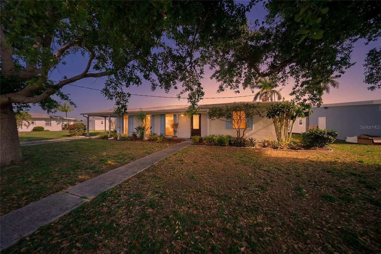 Oversized lot on the Mental Waterway with 94.7 feet of reinforced seawall. Just a five-minute boat ride—with only one bridge at Edgewater Dr—to open water and deep-water access, this property is perfectly positioned on a quiet cul-de-sac, offering true waterfront living at its best. This charming canal-front home provides direct access to Charlotte Harbor, making it ideal for boating enthusiasts and anyone seeking the ultimate Florida lifestyle. Situated along a wide canal, the spacious lot boasts a large backyard with ample room to relax, entertain, or even add a pool. Take in serene water views from your patio or enclosed lanai—perfect for morning coffee or evening sunsets. Inside, the home features a bright, open layout with generous living and dining areas. Large windows fill the space with natural light while highlighting the beautiful waterfront setting. The updated kitchen showcases modern cabinetry, sleek countertops, stainless steel appliances, and a stylish backsplash—creating a functional and inviting space for everyday living. Additional features include tile flooring throughout for easy maintenance, a dedicated laundry area, and flexible living spaces suitable for a home office, guest room, or hobby area. Located in a quiet, established neighborhood, the home is just minutes from Port Charlotte Town Center, along with a variety of shopping, dining, and daily conveniences. Enjoy quick boating access to Charlotte Harbor (approximately 5–10 minutes), plus nearby parks, golf courses, and Gulf beaches all within a short drive. Whether you're searching for a full-time residence, seasonal getaway, or investment opportunity, this waterfront property delivers on location, lifestyle, and endless potential.