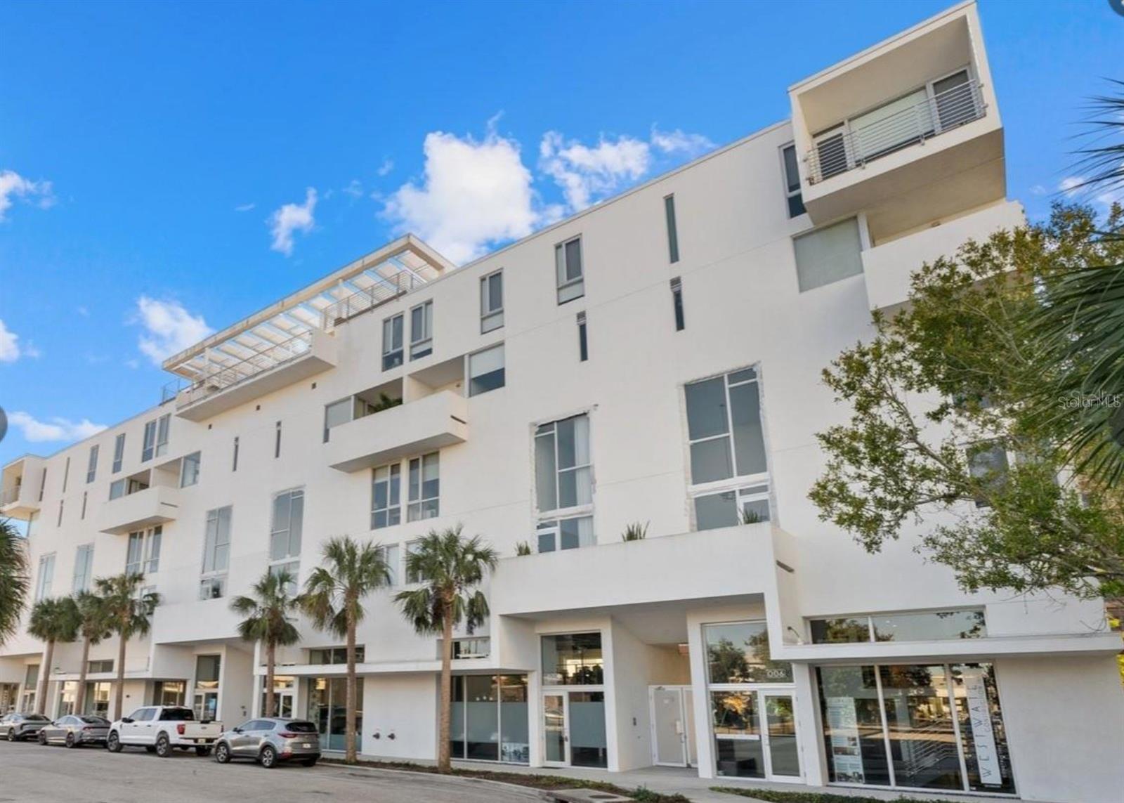 Experience sophisticated urban living in this stunning two-story, end-unit loft residence at Risdon on 5th, ideally situated in Sarasota's vibrant Rosemary District. Built in 2019 and designed by award-winning architects Halfants & Pichette, this architecturally distinctive condominium offers 1,836 square feet of thoughtfully designed living space with 3 bedrooms, 3.5 bathrooms, soaring ceilings, and dramatic floor-to-ceiling impact windows that fill the home with natural light.

Freshly painted and beautifully updated, the residence features a neutral color palette, new designer lighting and bathroom fixtures, automatic window shades, ceiling fans, and custom-fitted closets throughout. The spacious contemporary kitchen showcases a striking quartz waterfall island, Irpinia soft-close cabinetry, abundant counter space and storage, and a complete suite of brand new GE Café appliances. All three bedrooms feature private en-suite bathrooms, with dual vanities in both the primary and secondary suites, and a luxurious soaking tub in the second bath. Additional conveniences include dual-zone HVAC, a full-size LG washer and dryer, operable and floor-to-ceiling windows in every room, and generous under-stair storage.

Two private outdoor terraces extend the living space, offering inviting settings for relaxing or entertaining. Risdon on 5th features secure entry, semi-private elevator access, covered parking, a heated rooftop pool, and two rooftop social areas with panoramic views.

Just moments from The Bay waterfront park, restaurants, galleries, shopping, and Sarasota's renowned cultural attractions, this exceptional residence combines the architectural character of an urban loft with the convenience of downtown living. Furnishings are available for separate purchase.

A rare opportunity to enjoy contemporary loft-style living in one of Sarasota's most desirable downtown neighborhoods at an unbeatable price.