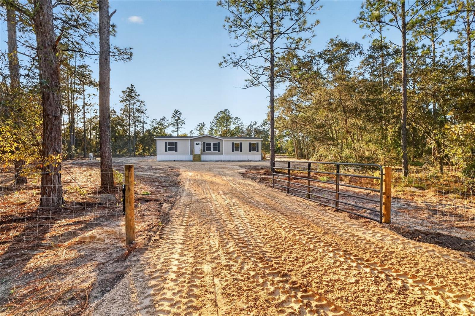 BRAND NEW NEVER LIVED IN BEFORE spacious Double-Wide home located on an Oversized 2+/- acres lot located in the Williston Highlands three lots in off main paved road E Levy ST with field fencing on all four property lines. NEW LIME ROCK DRIVEWAY! Beautiful 3 bedrooms, 2 full bathrooms with brand NEW everything inclusive of septic system, well, electric, AC, field fencing with entrance gate! Spacious Master bedroom includes walk-in closet, along with double vanity sink bathroom and shower bathing areas. Two additional large bedrooms each with roomy closets inside. High quality kitchen with brand NEW Stainless Steel appliances included. Features floor to ceiling cabinetry and multi-purpose kitchen island. Great for cooking, dining, or working! Just a few steps away is a utility area with space to plug in a washer and dryer. Large sliding glass doors that open up to an extended deck. Ample room to entertain and relax in the Living and Dining rooms. MOVE-IN READY ! Quiet, calming peaceful location.