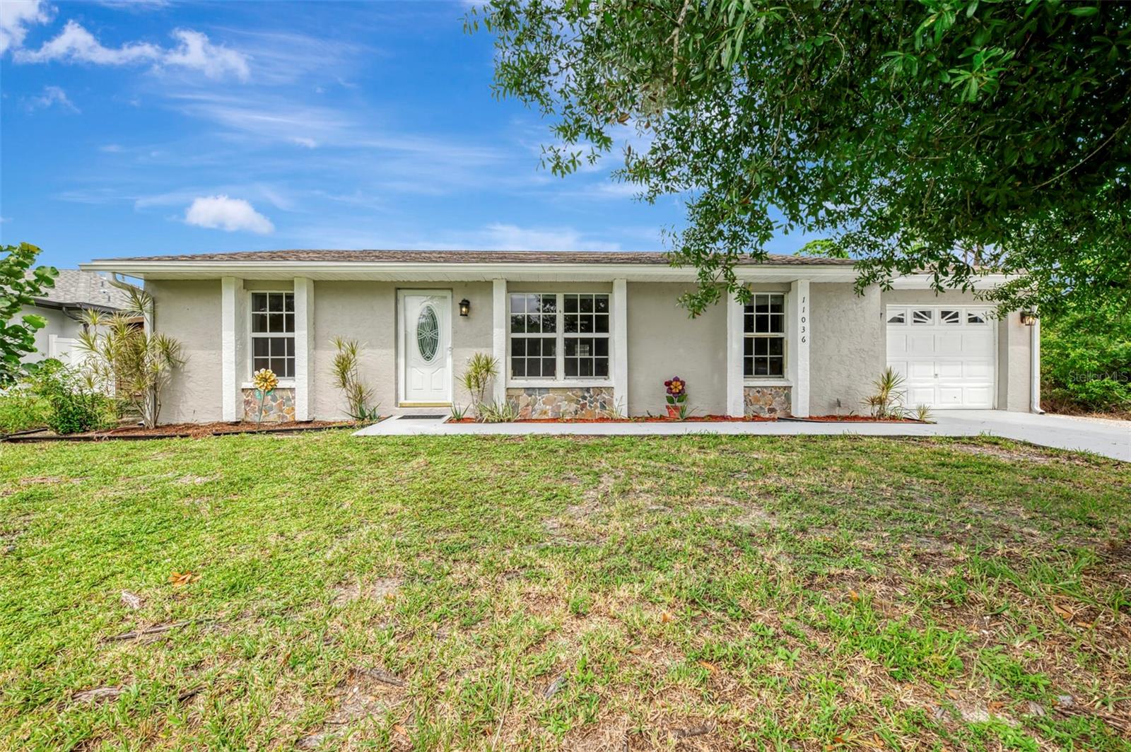Welcome to 11036 Jacqueline Avenue, a unique and versatile property in the heart of Englewood, FL. Whether seeking a winter retreat, first home, relocation or an investment property, this charming three-bedroom, two-bathroom, 1 car garage residence offers exceptional potential. Featuring a space-efficient split bedroom layout that showcases a separate living room, open kitchen, kitchenette, two generous size guest bedrooms and primary suite, the floorplan design maximizes the approximate 1,300 sq. ft. under air area. As you walk into this home you have a spacious living room, a primary suite off the living room and split bedrooms on the opposite side of the home with its own bathroom.  Your living room has a view of the front yard and is open to the kitchen. Enjoy a modern kitchen with granite countertops, backsplash, cabinets and a new dishwasher, refrigerator and oven in 2026. The breakfast bar overlooking the living room to make conversation and entertaining a breeze. The kitchen is open to the breakfast nook with a bay window giving plenty of natural light. There is a walk-in pantry that is 5 x 5 off the kitchen.  The kitchen also opens to a screened lanai porch, and it is approximately about 8 x 10 with two ceiling fans. The primary bedroom is a spacious ensuite with separate vanity area, shower and toilet separate and a large built-in closet for linens. Two private guest bedrooms both have walk-in closets and are conveniently located near the guest bathroom.  There is an additional built-in closet, in the hallway between the bedrooms for extra storage, linens, attire, etc. There is a separate laundry room with plenty of storage.  The laundry room has a door that opens to the side of the house as well.  You have a single garage with plenty of area for storage.  There is a separate concrete patio outside for your grilling.  The spacious yard offers plenty of room for pets, outdoor lounging, a shed, or the opportunity to create your own private backyard oasis. Englewood is a charming Gulf Coast town known for its uncrowded, natural beaches. This home's location is surrounded by many of the finest golf courses, not to mention world class fishing, easy access to beaches, shopping, and casual evening dining and entertainment.  Englewood East Park is just around the corner on the street behind this property.