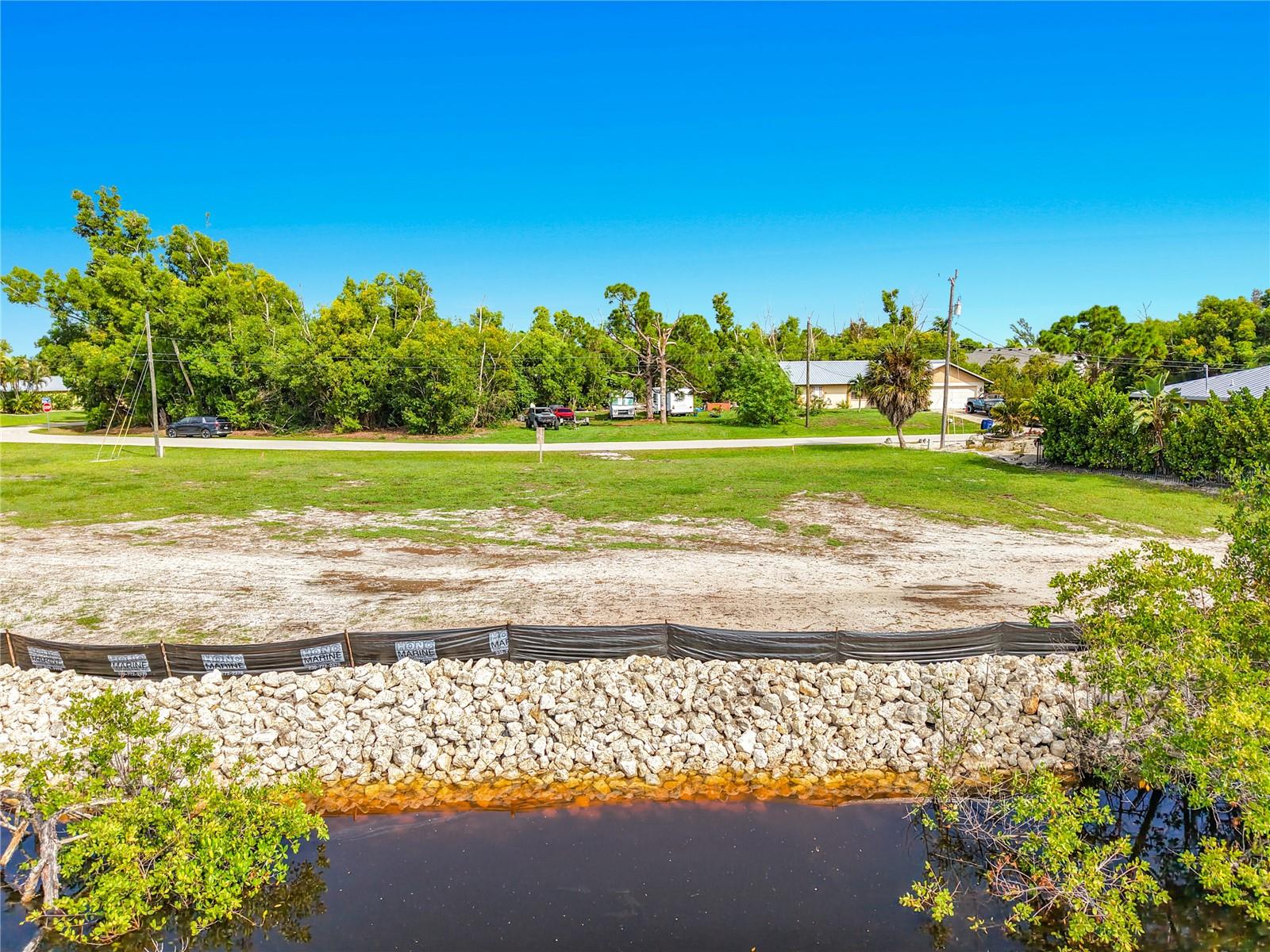 **WATERFRONT GULF-ACCESS LOT WITH BRAND-NEW RIP-RAP SEAWALL!** Discover the opportunity to build your dream coastal retreat on this cleared, ready-to-build waterfront lot in the desirable Charlotte Shores community of Bokeelia. Located just north of Pine Island Center, this property offers direct, no-bridge boating access to Pine Island Sound, Matlacha Pass, and the Gulf of Mexico. Boaters and anglers will appreciate the easy access to some of Southwest Florida's renowned fishing and boating waters. Whether you're heading out for a day of fishing, exploring the surrounding islands, or enjoying a sunset cruise, this location puts you close to it all. The brand-new rip-rap seawall adds valuable waterfront infrastructure to this exceptional homesite. Enjoy the peaceful, laid-back island lifestyle of Bokeelia while remaining conveniently close to shopping, dining, and everyday amenities. Punta Gorda and Fort Myers are within easy reach, and both Punta Gorda Airport and Southwest Florida International Airport provide convenient options for travel. Some of Southwest Florida's beautiful Gulf beaches are also nearby. If you've been looking for a waterfront lot where you can create a home designed around the Florida lifestyle, this is an opportunity worth exploring. Bring your plans, your boat, and your vision for waterfront living—Charlotte Shores is ready to welcome you home!