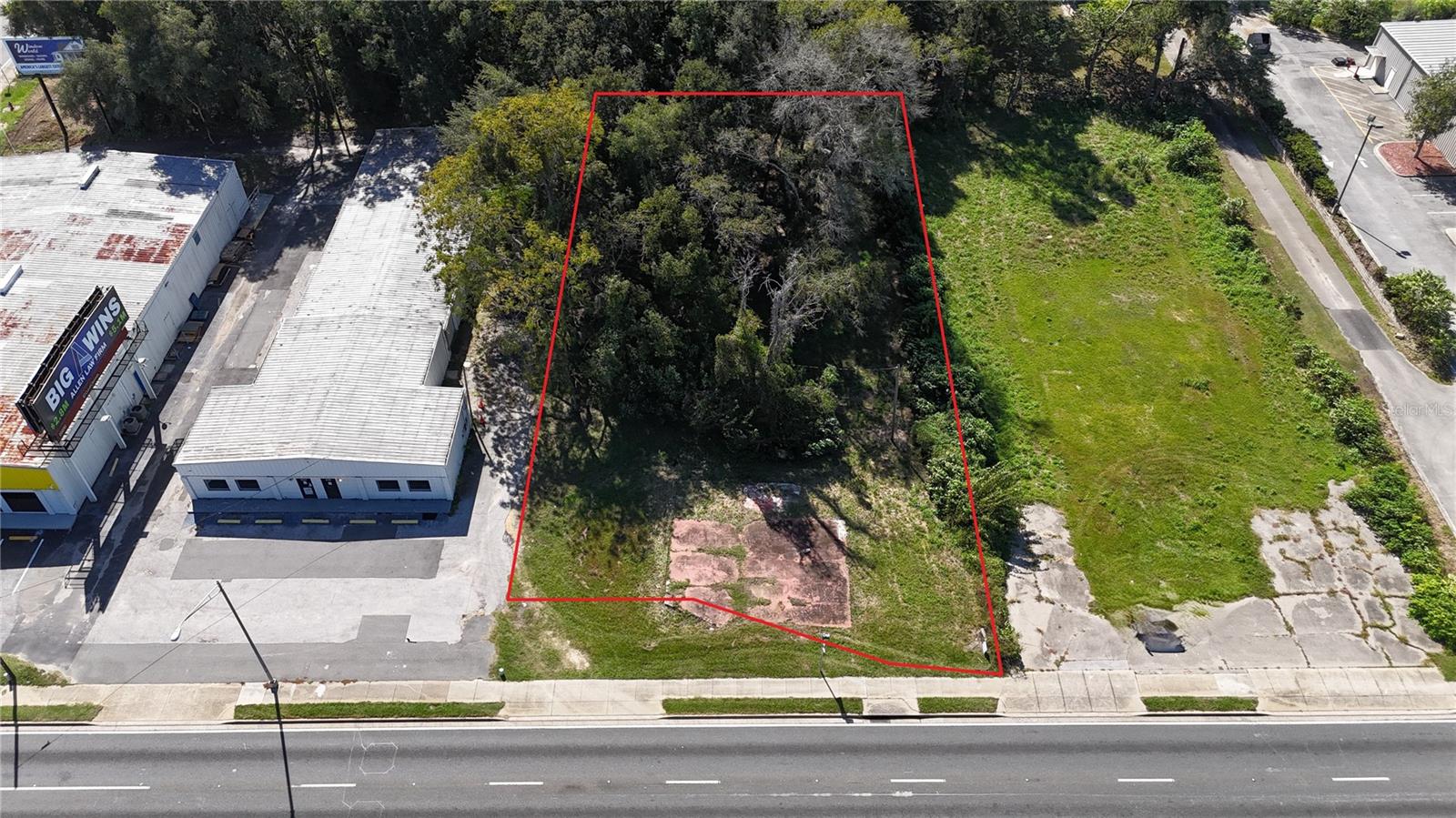 PRIME INDUSTRIAL LOT – EXCELLENT LOCATION & VISIBILITY. AADT of 22,500. Excellent opportunity to own a strategically located industrial parcel along highly traveled State Road 40 (Silver Springs Boulevard) in Ocala, Florida. This lightly wooded vacant lot offers over 100' of paved road frontage and outstanding exposure along one of Ocala’s major commercial corridors. Ideally situated just 270' west of the signalized intersection at SW 27th Avenue and less than one mile from the I-75 interchange, providing convenient access to Ocala's growing commercial and industrial markets. The property measures approximately 100' wide by 230' deep and features M-1 (Light Industrial) zoning with an Employment Center future land use designation, offering potential for a variety of commercial and light industrial uses, subject to applicable approvals. Location was once used for a bar/restaurant years ago - potential for impact fee waivers. With its desirable location, excellent accessibility, and proximity to I-75, this property presents a fantastic opportunity for business owners, developers, and investors looking to establish a presence in Ocala's expanding industrial market. Don't miss this opportunity to secure industrial land in a prime location. Potential Owner Financing.