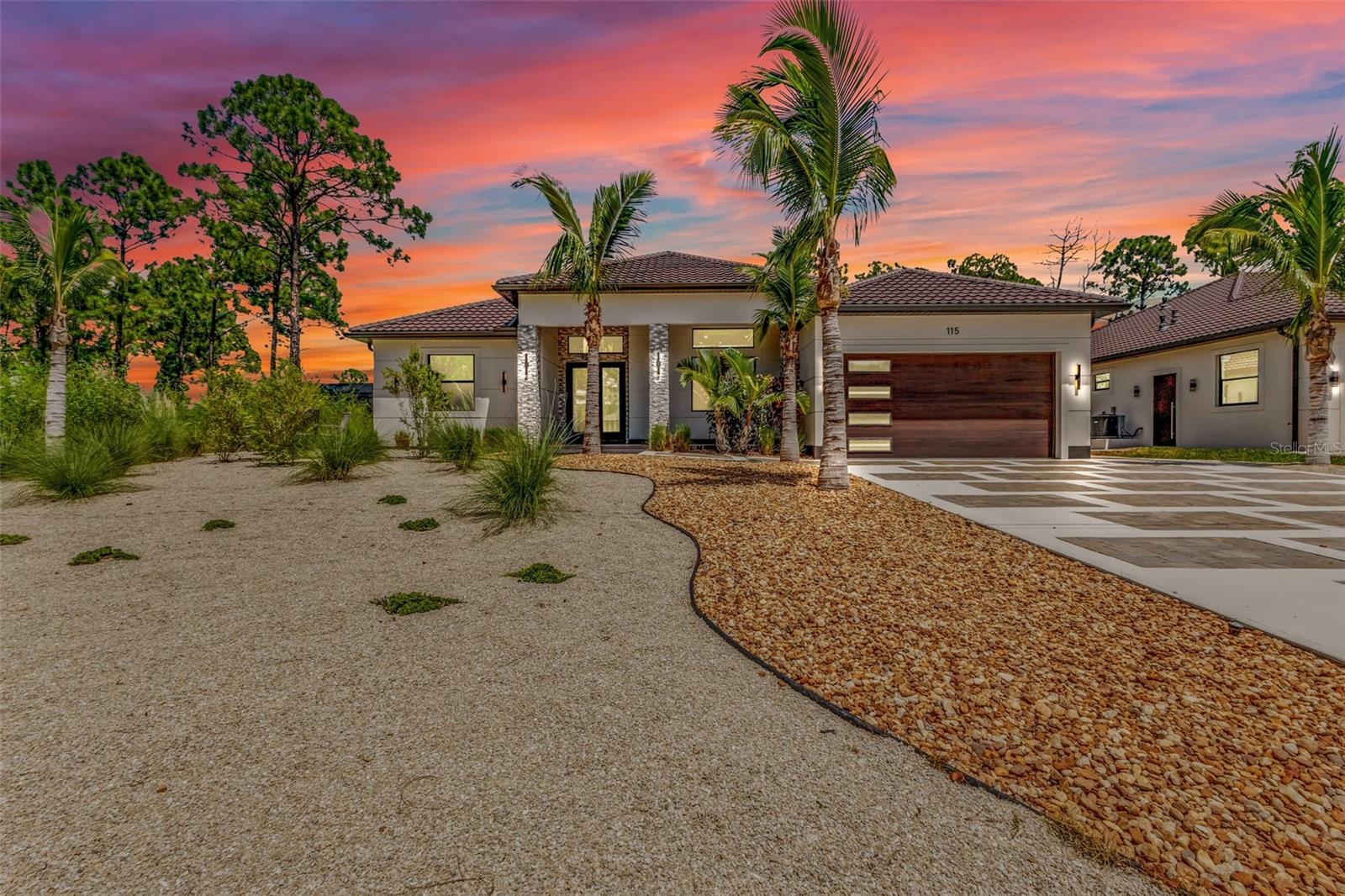 About a mile and a half from Warm Mineral Springs, this 2024 custom home has a private suite, a saltwater pool you can heat or chill, and a yard you never mow. No HOA. New custom homes are popping up all over the neighborhood. North Port has grown from about 75,000 people in 2020 to more than 100,000 today. The city has already started a $16.7 million rebuild at the spring. This is the early window to own here, before the park is complete.

3 bedrooms and 4 baths, 2,190 square feet, including an attached private suite. The suite has its own entrance, kitchenette, bedroom, full bath, custom closet with built-ins, laundry hookup for a stackable washer and dryer, and patio. Use it for parents, guests, or as its own wing. When your guests walk through the front door, they will not think they walked into another cookie-cutter house: 48-inch floor tile, Brazilian stone across the counters and backsplash, high-gloss cabinets, an oversized island, cooktop, separate oven, and a convection oven/microwave. Electric fireplace, a large flat-screen on a swivel arm, and a Bose sound bar. Primary suite opens to the pool, with a custom closet and a floor-to-ceiling porcelain bath — a glass-and-tile shower plus a jetted soaking tub. One guest bath has 3D porcelain tile. A GE washer and dryer in the garage convey. You reach them through an interior door, and you cannot hear them from inside the house.

Outside, a screened and lit saltwater pool with dual fountains sits in sun all day. Plenty of Florida pools sit on the shaded side of the house and stay cold. This one does not. Heat it or chill it year-round. Covered lanai with two ceiling fans and color-changing LED lights, a full bathroom with direct pool access, and an outdoor kitchen already wired and plumbed, with a wine cooler and a TV hookup in place. Mornings start with an unobstructed sunrise over the trees behind the house. Evenings end in the front garden seating, watching the North Port sky go orange and pink. The sweet scent of jasmine carries through the sliders and across the lanai while you eat breakfast.

No Florida grass to keep green, and no fight with watering restrictions. Crushed limestone, river stone, slow-growing plants, and ornamental grasses were deliberately chosen so landscaping costs stay low. Nothing to keep cutting back off the house. No mowing. No weekly lawn crew. Irrigation is already in. Three olive trees, coconut palms, some already fruiting, jasmine, and native Simpson's stoppers that bring in birds, butterflies, and dragonflies.

Warm Mineral Springs is Florida's only public warm mineral spring, listed on the National Register, about 85 degrees year-round, with one of the highest mineral contents of any spring in the United States. More than 150,000 people visit every year. About 400 visitors a day, a mile and a half from this home. The city is rebuilding the historic spa and admissions buildings now. Live here, host family, or look at rental demand from Warm Mineral Springs (one and a half miles), and from CoolToday Stadium (less than 4 miles).

Built in 2024. Metal barrel tile roof. Spray-foam insulation in the garage attic. Private well and septic, so no city water or sewer bill. Filtration under the kitchen sink. Concrete driveway with paver accents and a double-door entry. Two-car garage. Furniture conveys, including the Bose sound bar. For the buyer who wants a truly custom high-end home near the spring without surrounding-area prices or an HOA.