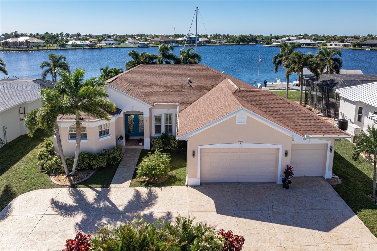 **SPECTACULAR 180-DEGREE WATER VIEWS OF EDGEWATER LAKE!** This exceptional 3 bed/2 bath waterfront pool home in Port Charlotte offers an extraordinary setting overlooking a wide, lake-like canal basin w/intersecting canals combined w/DESIRABLE SOUTHERN REAR EXPOSURE & DIRECT SAILBOAT ACCESS to Charlotte Harbor in UNDER 5 MINUTES! **NEW ROOF (2023) & COMPLETELY REMODELED KITCHEN (2026)!** The panoramic water views are truly the star of this property. Unlike traditional canal-front homes, the oversized lot enjoys sweeping views across the sparkling waters of Edgewater Lake, creating an incredible backdrop for everyday living. Watch boats pass by throughout the day, enjoy colorful evening skies & catch glimpses of dolphins playing, manatees passing through & ospreys, gulls and pelicans along the waterfront. Inside, the open floor plan takes full advantage of the waterfront setting w/large sliding glass doors in the great room that frame the view & extend the living space to the screened lanai. Architectural details include high ceilings, decorative tray ceilings w/crown molding, tile flooring, plantation-style shutters & an impressive etched-glass double-door entry w/arched transom window. The beautifully remodeled kitchen features white Shaker-style cabinetry, quartz counters, stainless steel appliances, a spacious breakfast bar & reverse osmosis water filtration. The adjacent breakfast nook offers yet another place to enjoy the water views while sipping your morning coffee. The master suite features a luxurious master bath w/custom dual-entry tiled shower, dual shower heads & separate soaking tub. Two guest bedrooms provide comfortable accommodations for visiting friends & family. Outside, the ENORMOUS SCREENED LANAI offers a front-row seat to the spectacular wide-water view. Relax under the covered dining area, lounge poolside or enjoy the in-ground pool w/ATTACHED SPA & spillover waterfall. Brick paver decking, mature Royal palms & a fenced backyard complete this incredible outdoor setting. Boaters will appreciate the 40 FT DOCK, 12,000 LB BOAT LIFT, 81 FT OF SEAWALL & five additional pilings positioned 25 ft offshore to accommodate larger boats. Water, electric & remote-controlled lighting are available dockside. NO BRIDGES between your backyard & Charlotte Harbor! **EXTENSIVE UPDATES & FEATURES** include NEW KITCHEN & APPLIANCES (2026), NEW ROOF (2023), NEW LANAI SCREENS (2026), NEW EXTERIOR PAINT (2026), A/C (2019), impact-resistant windows & sliding glass doors, reinforced garage doors, 15KW whole-house generator, central vacuum, security system, exterior Bahama shutters & attached THREE-CAR GARAGE w/RV outlet for EV charging station. A circular flagstone driveway, mature tropical landscaping & 11 FT FIRST-FLOOR ELEVATION add to the appeal. NO HOA FEES! Enjoy the best of Florida waterfront living w/an extraordinary view & your boat ready for its next adventure just steps from your back door. **MAKE AN APPOINTMENT TODAY & START LIVING YOUR FLORIDA DREAM!**