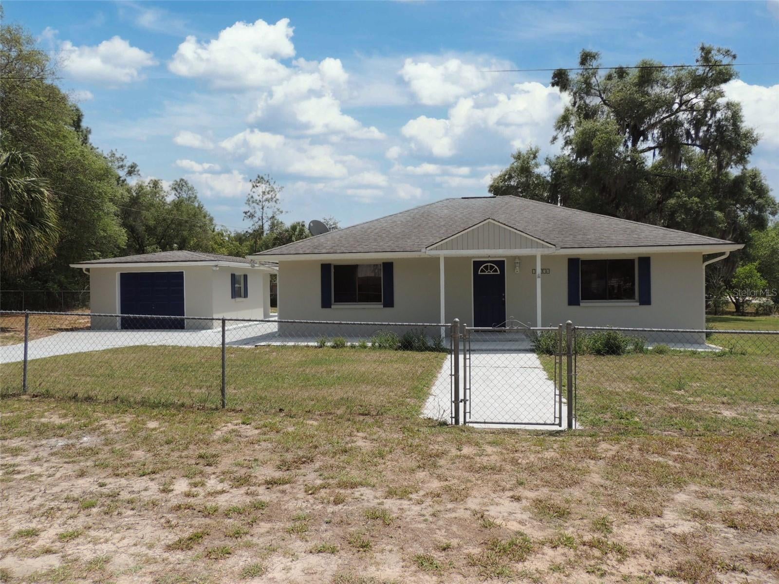 COMPLETELY REFRESHED, MOVE-IN READY CONCRETE BLOCK HOME ON A SPACIOUS CORNER LOT! Welcome to easy country living in this beautifully updated 2 bedroom, 2 bath home ideally located between Williston and Bronson, just off Highway 27Alt for a quick commute to town while still enjoying peaceful surroundings. Situated on a generous 0.44 acre corner lot, this property offers space, privacy, and functionality all in one. Step inside to discover over 1,500 square feet of comfortable living space, featuring a bright and inviting family room perfect for relaxing or entertaining. Family room has a full bathroom with a tiled stall shower and hall bathroom has a tiled tub/shower combination. Outside, the fully chain-link fenced yard provides a secure space for pets, play, or gardening, while the detached garage with additional storage area ensures you’ll have room for vehicles, tools, and hobbies. An inside laundry room adds everyday convenience to this well-designed home. Whether you’re looking for a full-time residence, a weekend retreat, or an investment opportunity, this solid concrete block home delivers durability, comfort, and value in a desirable rural location—just minutes from Williston, Bronson, and an easy drive to Gainesville or Ocala. Don’t miss your chance to own this move-in ready gem with room to spread out and enjoy the Florida lifestyle!