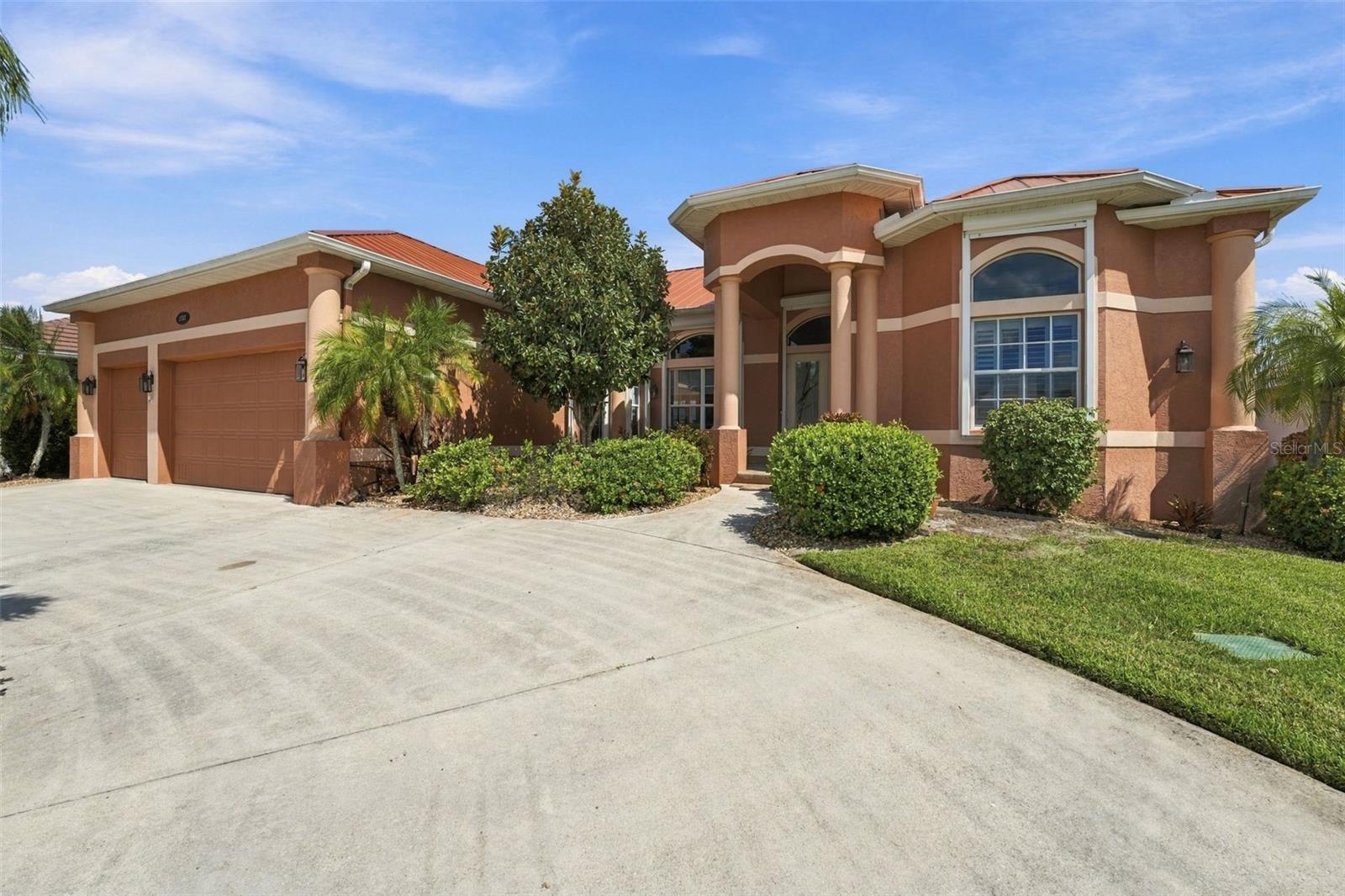 Virtually Staged. A BOATER'S PARADISE, SAILBOAT ACCESS, A SPECTACULAR CANAL VIEW, AND A CUSTOM-BUILT WATERFRONT HOME IN PUNTA GORDA ISLES. Located in the deed-restricted Bird Section, this 2,763-square-foot, 3 BED + Den, 3 CAR GARAGE residence combines gracious living spaces with a distinctive waterfront setting. A charming coastal color palette creates a relaxed, welcoming feel throughout. At the back of the home, the great room looks out across the canal, while the screened lanai and recently upgraded saltwater pool create an inviting setting for relaxing or entertaining. The pool features refinished gunite, programmable lighting, and new pavers; an outdoor shower, half bath, and storage closet complete the lanai. The home is along the Christmas Boat Parade route, with views of the decorated boats from the family room and lanai. The spacious kitchen features warm wood cabinetry, rich granite countertops, and a coordinating tile backsplash. Stainless steel appliances include a gas range beneath a statement vent hood and a built-in double oven. Glass-front display cabinetry, abundant storage, generous work surfaces, and a central island with seating make the kitchen both functional and inviting. The floor plan also offers a living room open to the dining area, a breakfast nook, and a den. A double-sided fireplace is visible from both the living room and primary bedroom. The primary suite features double doors to the lanai, two walk-in closets, and an ensuite bath with dual sinks, a walk-in shower, and a jetted tub. The split-bedroom layout includes two guest bedrooms, each with extended storage above the closet. Twelve-foot ceilings and PLANTATION SHUTTERS add to the home’s character, while BAHAMA shutters accent the north- and south-facing windows. The extended dock with SLIDE-MOOR system, water, and electric makes boating access convenient. From Alligator Creek, a scenic boat ride through the harbor leads to Boca Grande Pass and out to the Gulf. Additional highlights include a 2023 METAL ROOF, 250-gallon UNDERGROUND PROPANE TANK, three-car garage with storage, whole-house water filtration, and whole-home storm protection, including remotely operated electric shutters at the rear. Downtown Punta Gorda, Fishermen’s Village, Sunseeker Resort, restaurants, and entertainment are nearby.