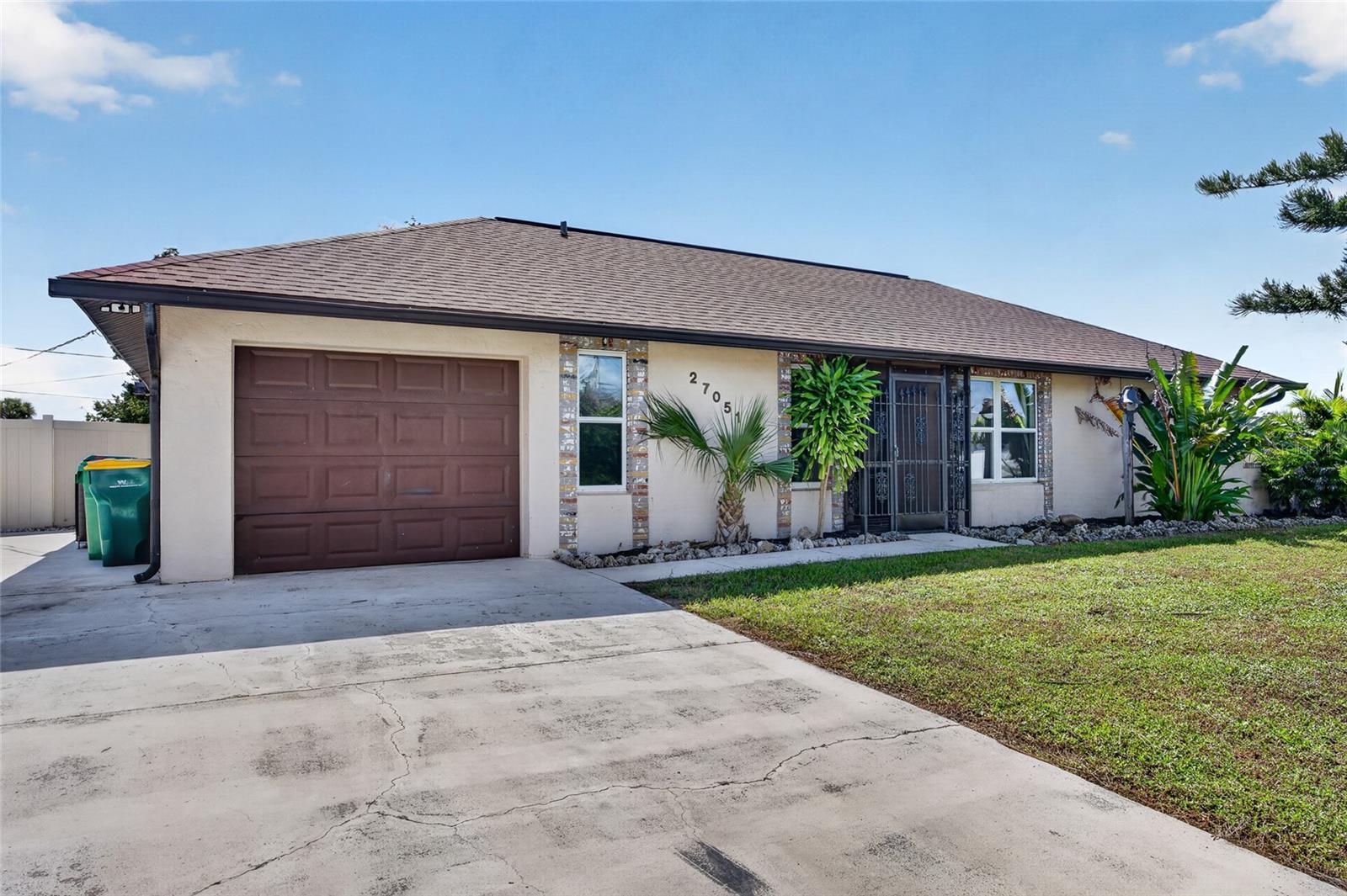 Welcome to 27051 Cougar Place, a beautifully updated Punta Gorda home where space, freedom, and peace of mind come together. Set on an OVERSIZED 0.37-ACRE HOMESITE made up of THREE LOTS in the Harbour Heights area, this 2-BEDROOM, 2-BATHROOM, 1-CAR GARAGE HOME offers 1,503 square feet of living space, a SPACIOUS SUNROOM, a SCREENED LANAI WITH AN IN-GROUND SPA, and NO HOA, giving you room for your boat, your RV, and all of your toys.

The big-ticket items have already been taken care of. The ROOF WAS REPLACED IN 2023, the A/C was updated in 2023/2024, ALL WATER LINES WERE REPLACED WITH PEX PLUMBING in 2026, and a BRAND-NEW SEPTIC TANK AND LEACH FIELD were installed in 2026. A TANKLESS WATER HEATER WITH FILTER, HURRICANE SHUTTERS, newer ceiling fixtures, a FENCE REDONE IN 2024, and a refreshed screen enclosure add even more value and peace of mind.

From the moment you arrive, the covered front porch and a striking LEADED-GLASS FRONT DOOR with a WROUGHT-IRON SECURITY SCREEN DOOR create a welcoming first impression. Inside, the bright, open LIVING AND DINING AREA is filled with natural light and ceiling fans. Just beyond, the SUNROOM, measuring approximately 25' x 12', is lined with windows and offers wonderful bonus space for a family room, game room, or home office.

The KITCHEN features crisp WHITE CABINETRY, a PANTRY, a BREAKFAST BAR, and STAINLESS STEEL APPLIANCES, making everyday cooking easy and enjoyable. The PRIMARY SUITE offers a WALK-IN CLOSET and an ensuite bath with a VANITY/MAKEUP SPACE and a WALK-IN SHOWER, while the second bedroom sits near the second full bath with a tub/shower combination, ideal for guests.

STEP OUTSIDE AND DISCOVER YOUR OWN BACKYARD RETREAT. Sliding glass doors open to a LARGE SCREENED LANAI, approximately 26' x 17', with ceiling fans and an IN-GROUND SPA, the perfect place to unwind at the end of the day. A separate COVERED PATIO adds even more room to entertain, and the FULLY FENCED BACKYARD offers plenty of space to garden, play, or simply relax.

FOR THE BOATER, RV OWNER, OR HOBBYIST, THIS PROPERTY DELIVERS. A DETACHED METAL CARPORT and PARKING PAD provide extra covered parking, and the attached garage with opener also houses the laundry. With NO HOA, the rules are yours to make.

MORE THAN A HOME, THIS IS SPACE, FREEDOM, AND PEACE OF MIND WITH THE MAJOR UPDATES ALREADY DONE. Conveniently located off Harbor View Road with easy access to US-41, I-75, shopping, and dining, 27051 Cougar Place offers an exceptional opportunity to enjoy relaxed Punta Gorda living at its finest.