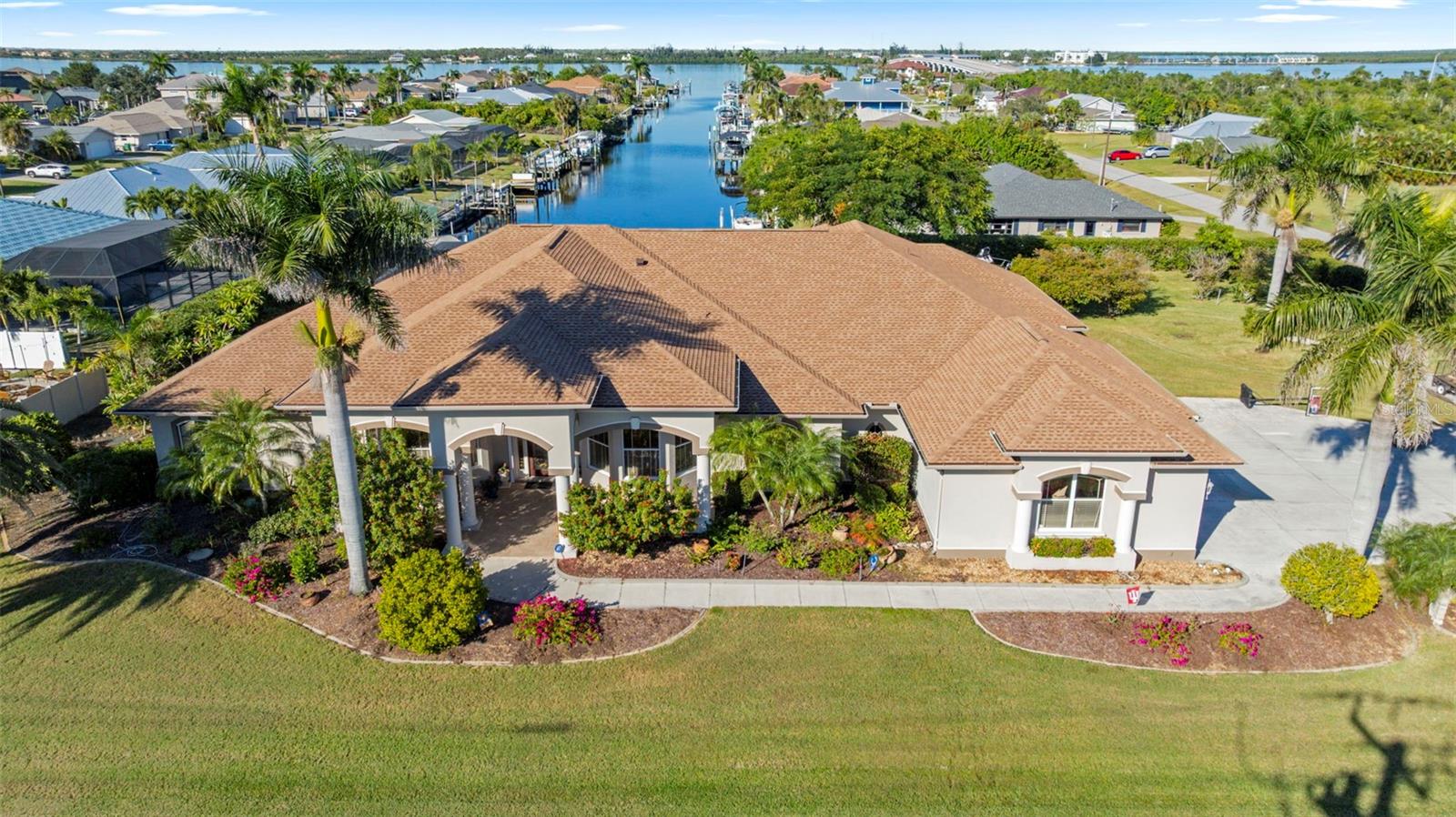 Just STUNNING! Discover an exceptional estate home that blends luxury and true Florida waterfront living. Perfectly positioned on three waterfront lots—totaling over three-quarters of an acre—this custom 4,265 sq. ft. residence offers sweeping views of the wide canal leading straight out to the Myakka River. Built with meticulous attention to detail, this 3-bedroom plus office, 3.5-bath pool home showcases refined architectural features including crown molding, step and coffered ceilings with custom lighting, built-in illuminated display cases, and and one elegant fireplace. French doors throughout the home open to an expansive 24' x 94' lanai, engineered for unobstructed water views creating a truly unique indoor–outdoor living experience. The chef’s kitchen impresses with high-end custom cabinetry, granite countertops, a large center island, breakfast bar, convection wall oven and microwave, stainless steel GE Monogram appliances, and picturesque views of the pool and canal. A built-in desk adds convenience for daily tasks. The serene master suite features a spacious sitting area, custom closet organizers, and a luxurious bath with separate vanities, a soaking tub, and a walk-in shower. Additional highlights include an intercom system, a state-of-the-art security and exterior video monitoring system, and an oversized 1,049 sq. ft. three-car garage complete with built-in cabinetry and pull-down attic access—ideal for car enthusiasts or hobbyists. The home also features a new roof installed in 2023, adding long-term value and reassurance. Outdoor living is elevated with a heated 15' x 33' saltwater pool with waterfall and an exterior shower. The pool cage was recently replaced and upgraded with oversized 6" gutters. The lanai is pre-plumbed and pre-wired for a future outdoor kitchen, making it perfect for entertaining in true Florida style. Boating and water-sport enthusiasts will appreciate the 62-foot dock with a 9,000-lb. boat lift, electric and water hookups at the dock, plus two additional jet-ski lifts located on the third lot. A 50-amp RV hookup provides added convenience for guests or recreational vehicles. Whether you enjoy boating, fishing, kayaking, or simply relaxing by the water, this home offers a lifestyle that is both luxurious and effortlessly coastal. Begin your next chapter in the prestigious riverfront community of Gulf Cove—where every day feels like a retreat.