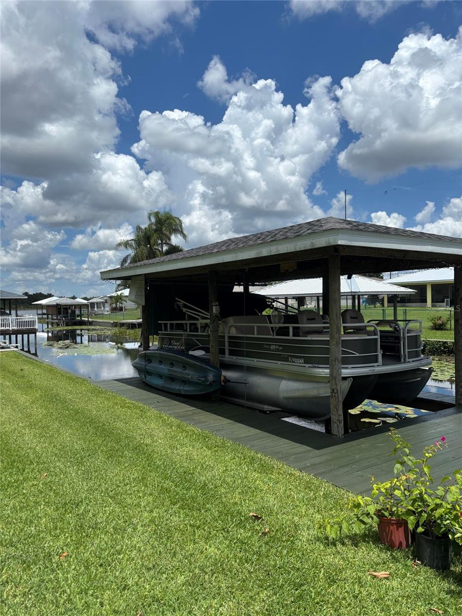Lake living at its finest! This beautiful home, built in 2022, has been thoughtfully enhanced since its purchase in 2023. Enjoy direct lake access with a private boathouse and boat lift. The property features an expansive 10' x 55' screened rear porch, an 8' x 16' storage shed, a whole-home water softener system, faux wood blinds throughout, and a washer and dryer with upper and lower cabinetry. Recent exterior painting adds to the home's appeal. An additional concrete parking pad provides extra space for vehicles, a boat, recreational equipment. Don't miss this opportunity to enjoy waterfront living with modern upgrades and amenities.