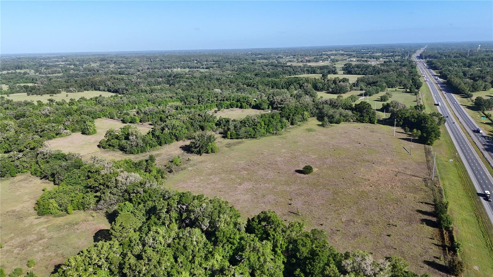 Welcome to this 117+/-acre property, ideally situated just off the I-75 and 326 exit, and a mere 15-minute drive to the vibrant heart of town. This property offers a unique blend of seclusion and accessibility, making it perfect for both agricultural pursuits and residential living.
The entire property is fully fenced and cross-fenced.  At the heart of the farm is a large metal barn, accompanied by two paddocks. Ideal for equestrian enthusiasts or livestock management.
Water is abundant with two functional wells on-site, providing reliable resources for farming operations or personal use. 
Currently home to cattle, this property was previously known as Pleasant Crest Farm, showcasing its rich agricultural history. Please note that cattle, machinery, and equipment are not included in the sale.
The property comprises two combined parcels (Parcel Numbers: 12759-000-00 and 12964-000-00). Additionally, the county estimated the frontage to be an impressive 4,300 feet, offering ample opportunities for development or expansion.
Don’t miss this chance to own a versatile and beautifully located farm with endless potential!