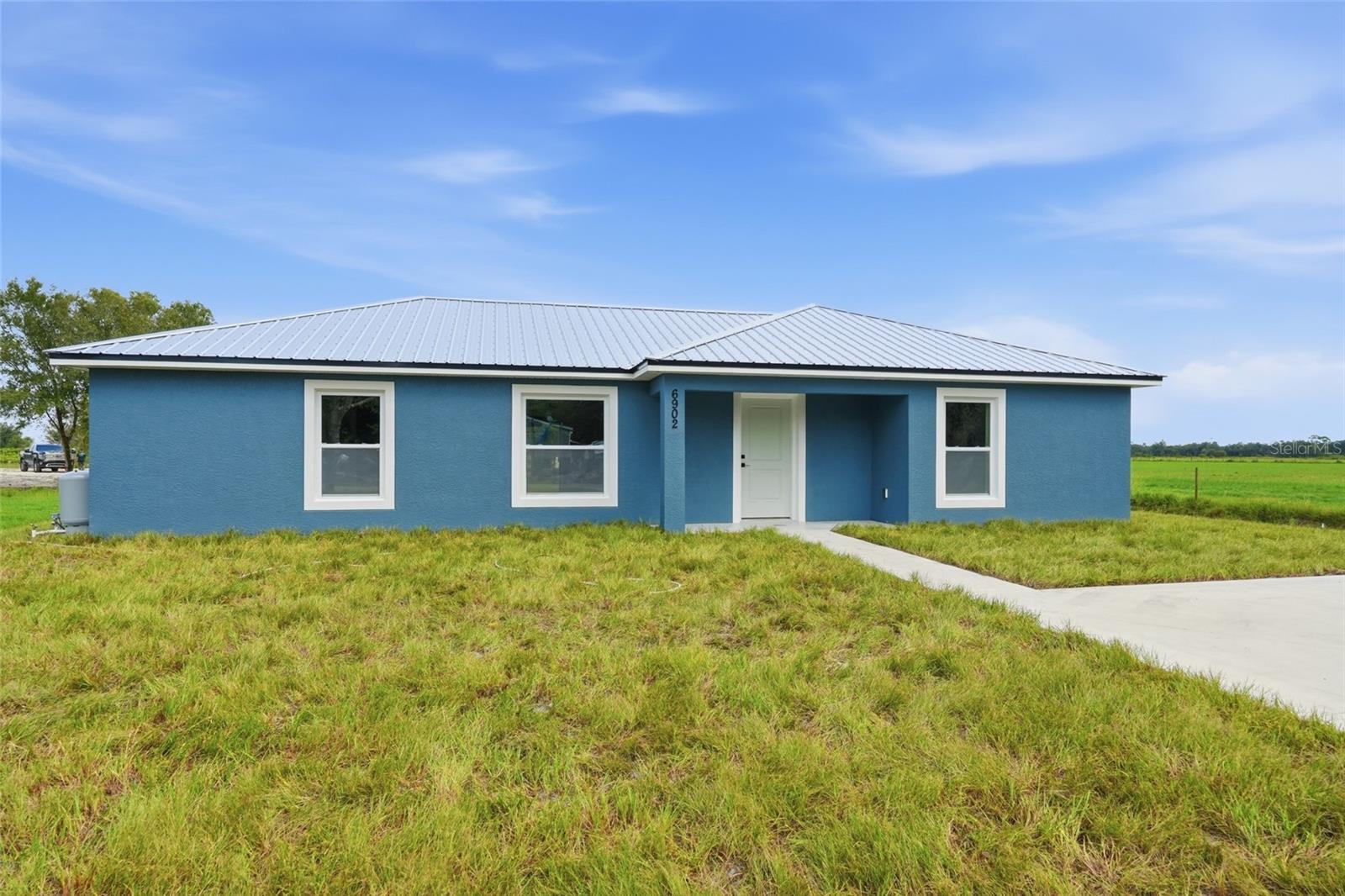 Brand new construction, nearly a third of an acre, and the kind of floor plan that makes everyday living feel a whole lot easier! If you've been waiting for a home where you can move in, unpack, and actually enjoy being a homeowner instead of inheriting someone else's to-do list, this one deserves your attention!

Built in 2026, this three-bedroom, two-bathroom home combines the benefits of new construction with something buyers are always looking for: SPACE! With concrete block construction, a durable metal roof, and quality craftsmanship from one of our area's trusted local builders, this home was built with Florida living in mind. Inside, the open floor plan gives you the flexibility to live the way you actually live. The kitchen flows seamlessly into the dining and living areas, making everything from busy weekday mornings to hosting friends and family feel effortless. You'll love the beautiful new finishes, functional layout, and oversized pantry that gives you plenty of room to keep everything organized. The split-bedroom floor plan offers privacy, with the primary suite positioned on one side of the home and two additional bedrooms on the opposite side. There's even a dedicated laundry room, because practical spaces make a bigger difference in everyday life than most people realize! But don't overlook what you're getting OUTSIDE! Sitting on nearly a third of an acre, this property gives you room to create a backyard you'll actually use. Imagine weekend cookouts, pets enjoying the yard, a garden you've always wanted, or simply having enough outdoor space to spread out. The back patio is the perfect starting point for enjoying those beautiful Florida evenings. Now let's talk about one of the biggest reasons buyers love new construction: fewer surprises! You're getting a brand-new roof, HVAC system, appliances, and finishes. No wondering how much life is left in the air conditioner. No budgeting for someone else's outdated kitchen. No immediate list of renovations before the house finally feels like yours. Just the opportunity to move into a home where everything is fresh and ready for its very first owner! New construction may also offer advantages when it comes to insurance and maintenance costs. And here's another detail worth knowing. This home is being built by a respected local builder known for quality craftsmanship and standing behind their work. Because WHO builds your home matters just as much as WHAT goes into it! You shouldn't have to choose between the features you want today and the peace of mind you'll appreciate tomorrow. With modern construction, a thoughtful layout, a spacious homesite, and everything brand new, this home gives you the best of both worlds. If you've been comparing older homes that need updating with new construction that doesn't offer much yard space, this might be exactly what you've been waiting for!