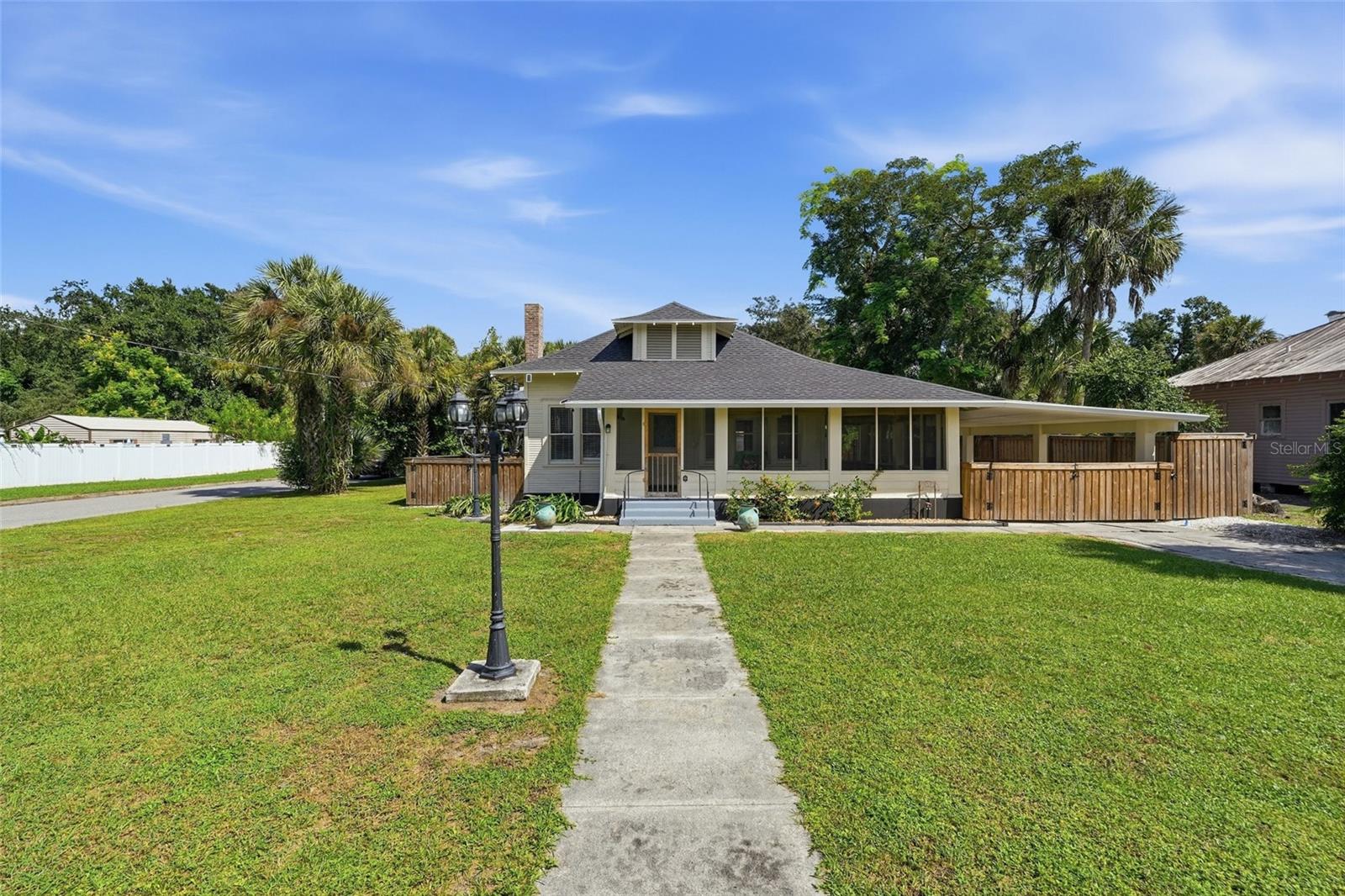 Straight out of a storybook and full of historic charm, this beautifully restored bungalow is the kind of home that makes you fall in love the moment you pull up! Situated on a charming corner lot, this three-bedroom, two-bathroom home has been thoughtfully renovated from top to bottom while preserving the character that makes it so special. Picture slow mornings sipping coffee on the updated wraparound front porch, afternoons curled up with a good book, and evenings entertaining friends and family in a home that feels just as inviting as it looks. Step inside to find an abundance of natural light pouring through the windows, a spacious living room that flows effortlessly into the dining area, and a private bonus room tucked behind beautiful barn doors that's perfect for a home office, reading nook, or quiet retreat. The completely remodeled kitchen is a showstopper, featuring granite countertops, gorgeous cabinetry, recessed lighting, and stainless steel appliances purchased in 2024. All three bedrooms offer generous space and plenty of natural light, and both bathrooms have been beautifully renovated! One of the bathrooms is a true standout, featuring the home's original clawfoot soaking tub brought back to life and paired with a stunning herringbone accent wall that perfectly blends historic character with modern design. You'll also appreciate the oversized dedicated laundry room that offers additional flexibility for storage or workspace. Outside, the charm continues with a fenced backyard, detached garage/storage building, and curb appeal that's hard to beat! And while this home may have historic roots, the important updates have already been taken care of, including a 2023 roof, new electrical panel with generator/RV hookup installed in 2024, and gutters installed around the entire home in 2025. The SimpliSafe security system equipment also conveys. And here's the cherry on top: THIS HOME IS BEING PARTIALLY FURNISHED! That's right, most of the furniture you see in the listing photos is included, making this an incredible opportunity for a move-in-ready home with personality! Centrally located less than ten minutes from downtown shopping, local cafés, bookstores, restaurants, schools, and everyday conveniences, you'll have the charm of a historic home without sacrificing accessibility. Beautifully restored, full of character, and ready for its next chapter. All that's missing is YOU!