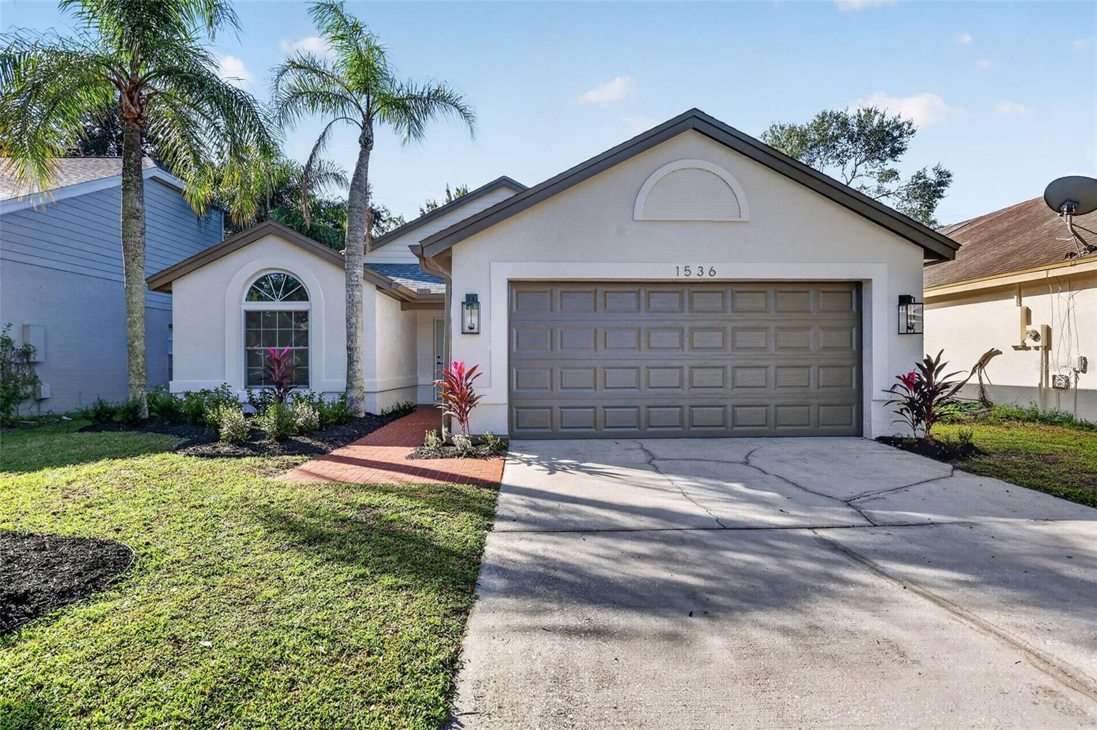 This 3-bedroom, 2-bath single-story home offers approximately 1,503 square feet of living space and a private screened-in pool and spa, creating an inviting setting for outdoor relaxation and entertaining. The split-bedroom floor plan features an open living and dining area, vaulted ceilings, and a wood-burning fireplace.